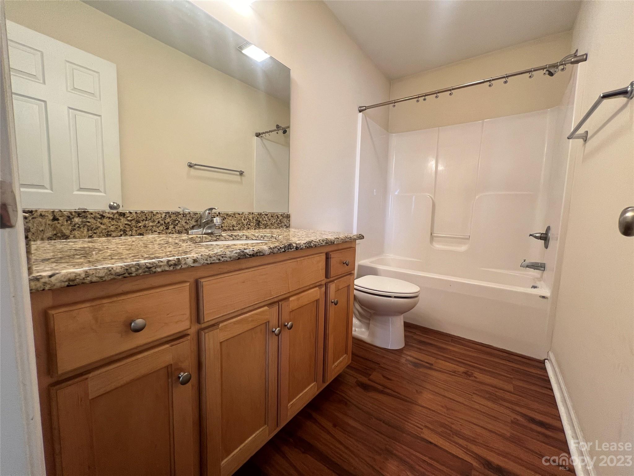 3835 Lee Moore Road Maiden, NC 28650 - Photo 11 of 16 a bathroom with a granite countertop sink toilet and shower