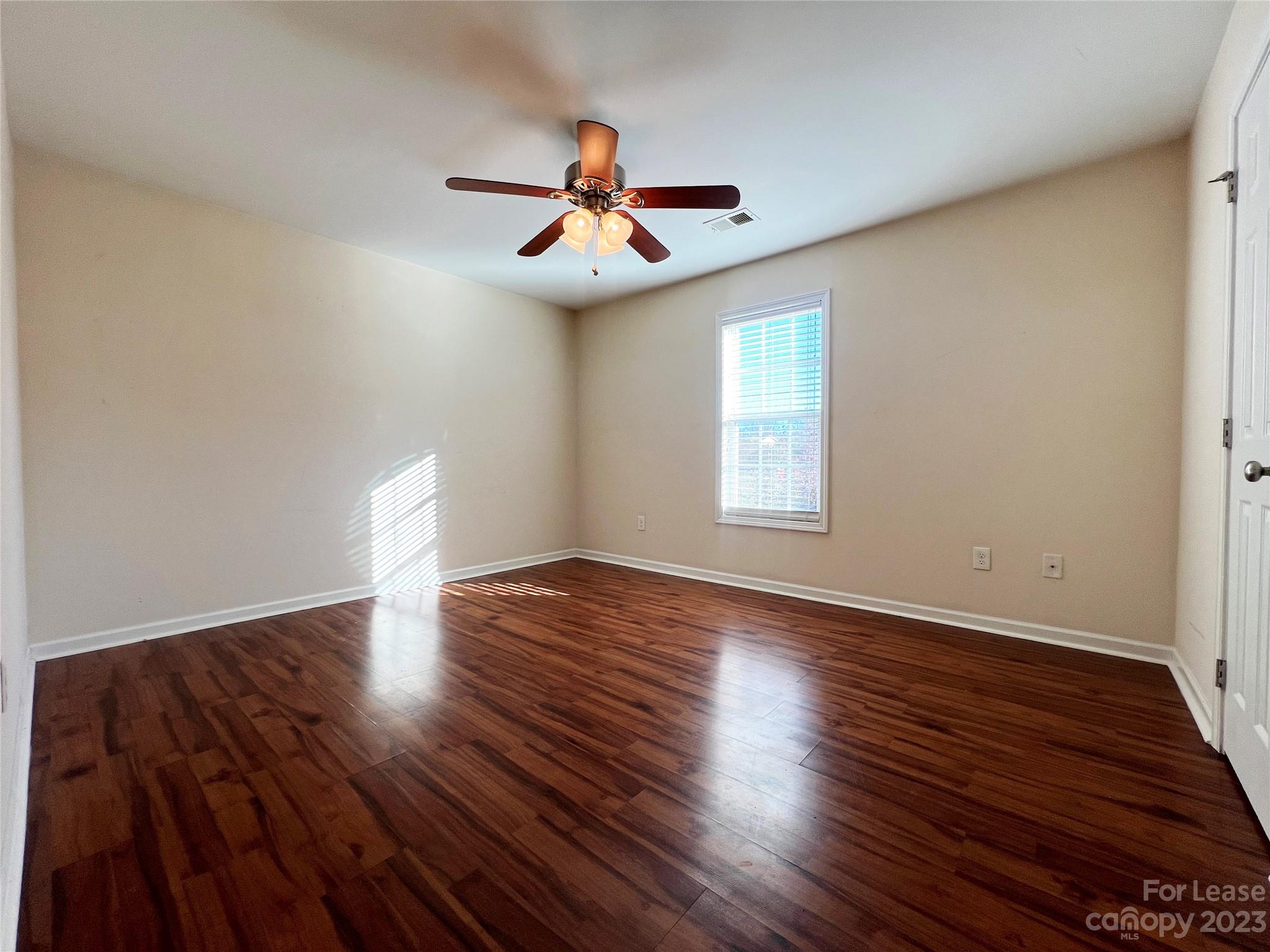 3835 Lee Moore Road Maiden, NC 28650 - Photo 12 of 16 a view of an empty room with wooden floor and a window
