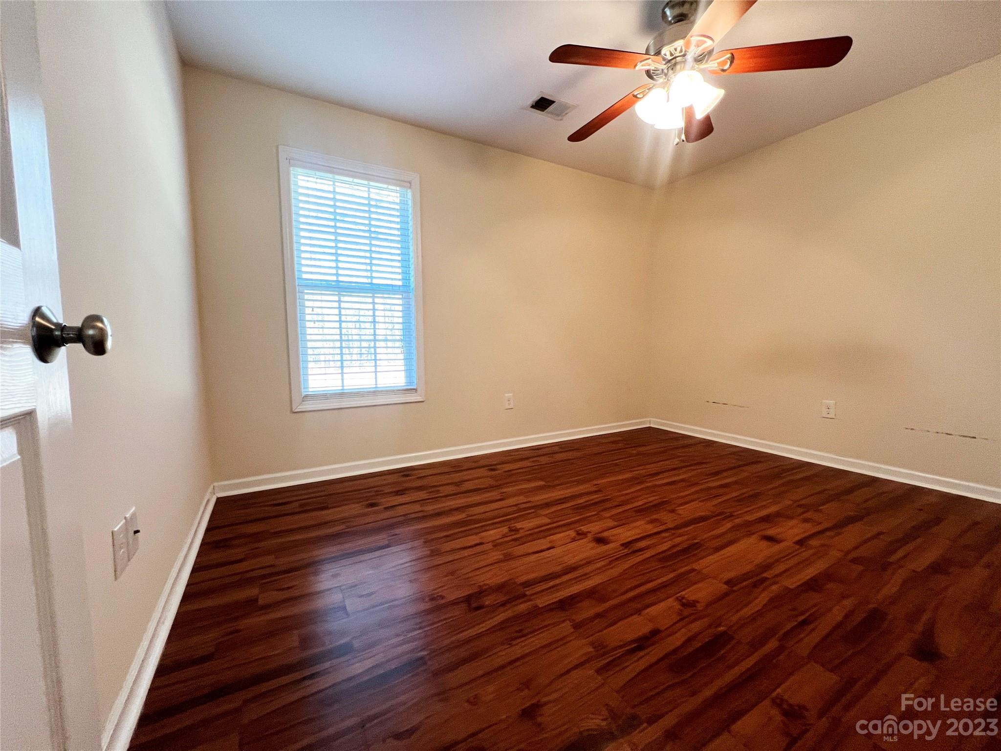 3835 Lee Moore Road Maiden, NC 28650 - Photo 13 of 16 wooden floor in an empty room with a window