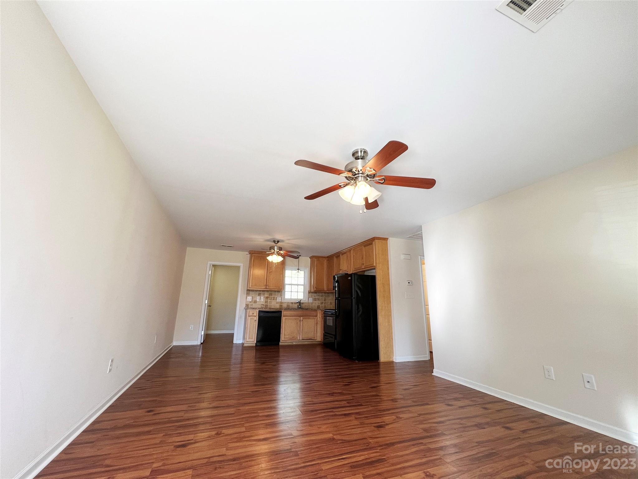 3835 Lee Moore Road Maiden, NC 28650 - Photo 3 of 16 a view of empty room with wooden floor and fireplace