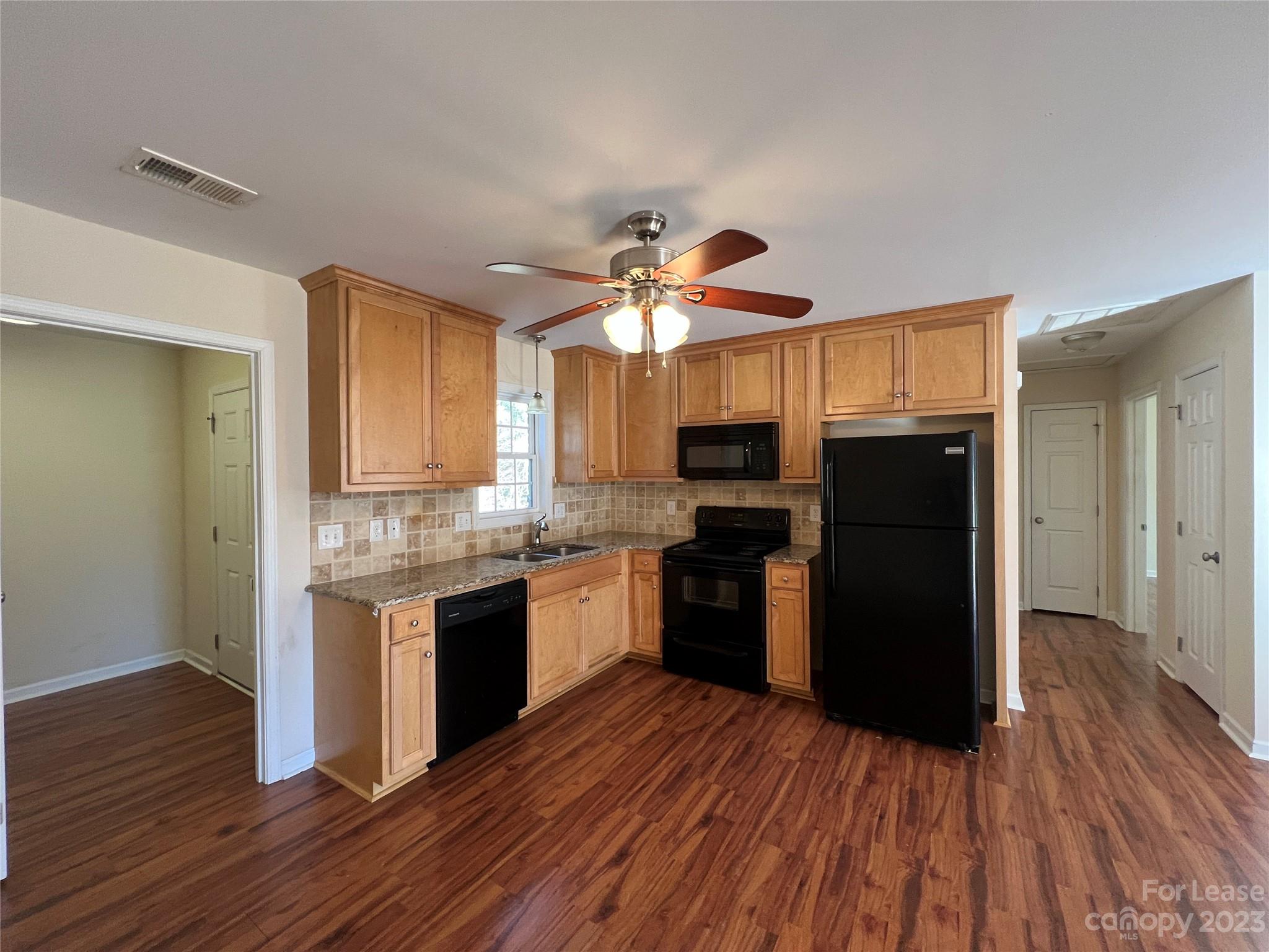 3835 Lee Moore Road Maiden, NC 28650 - Photo 6 of 16 a kitchen with granite countertop a refrigerator stove and sink