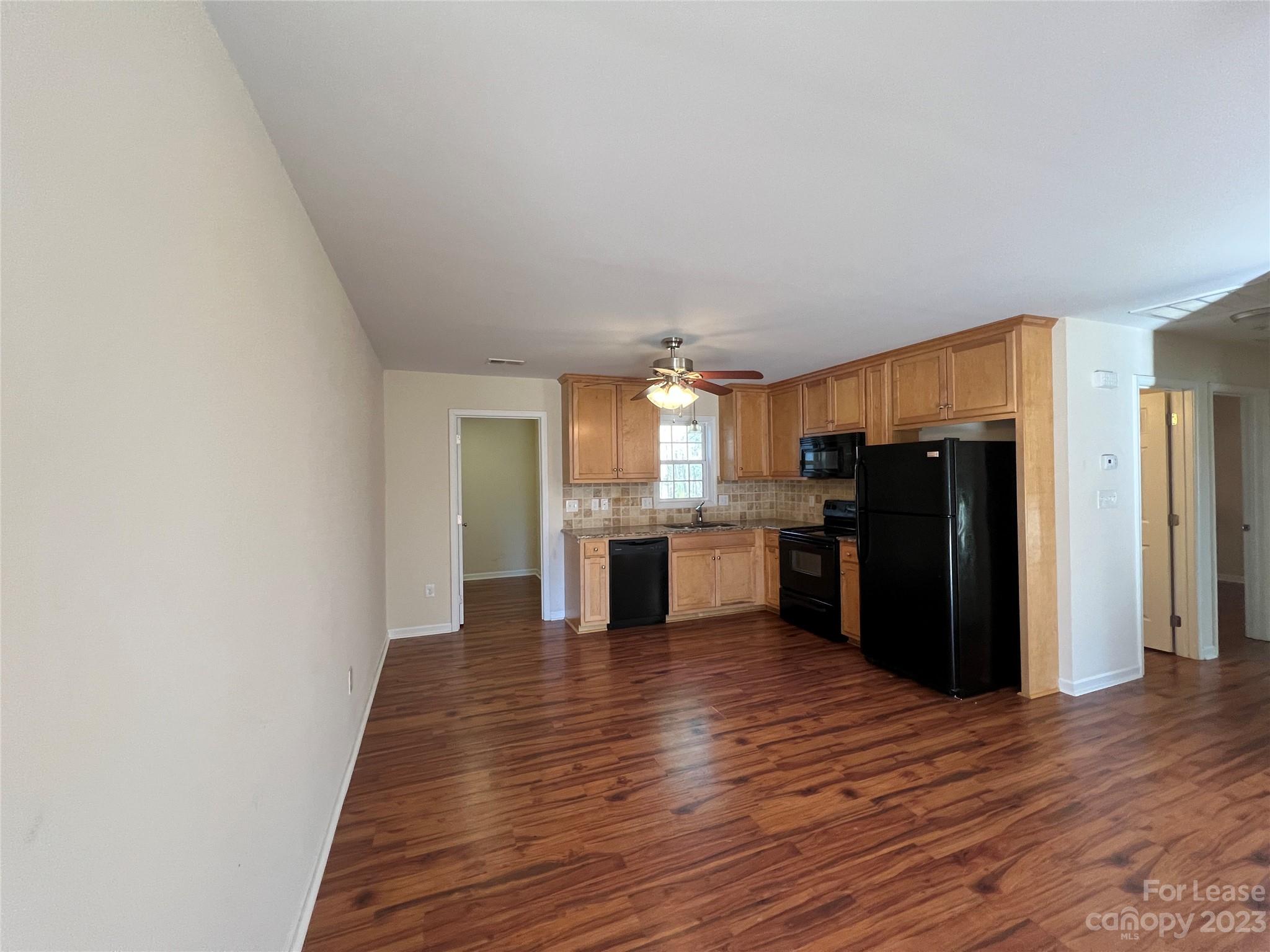 3835 Lee Moore Road Maiden, NC 28650 - Photo 7 of 16 a view of a kitchen with wooden floor and electronic appliances