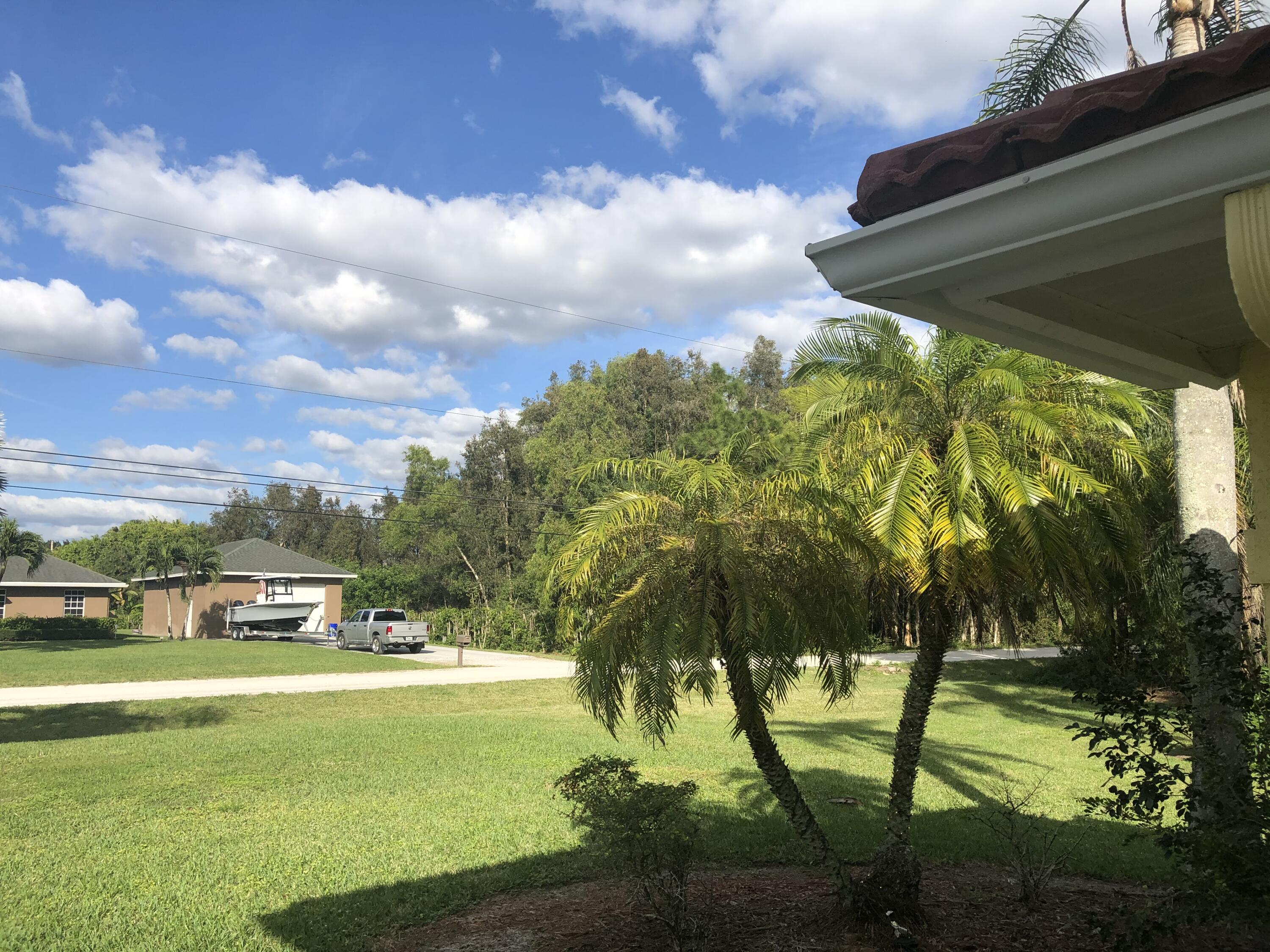 12136 88th Place North West Palm Beach, FL 33412 - Photo 24 of 29 a view of yard with swimming pool and green space