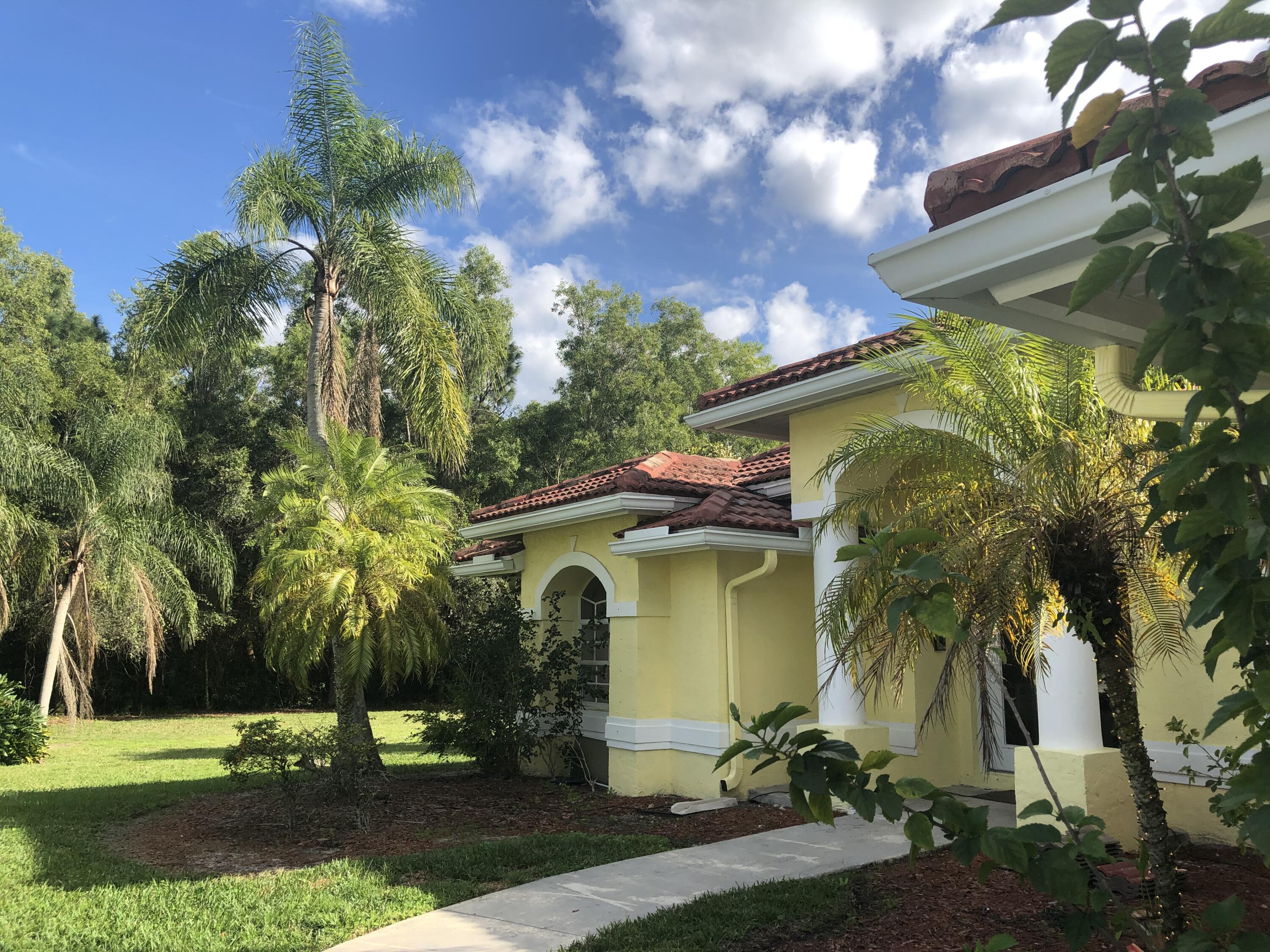 12136 88th Place North West Palm Beach, FL 33412 - Photo 28 of 29 a front view of a house with garden