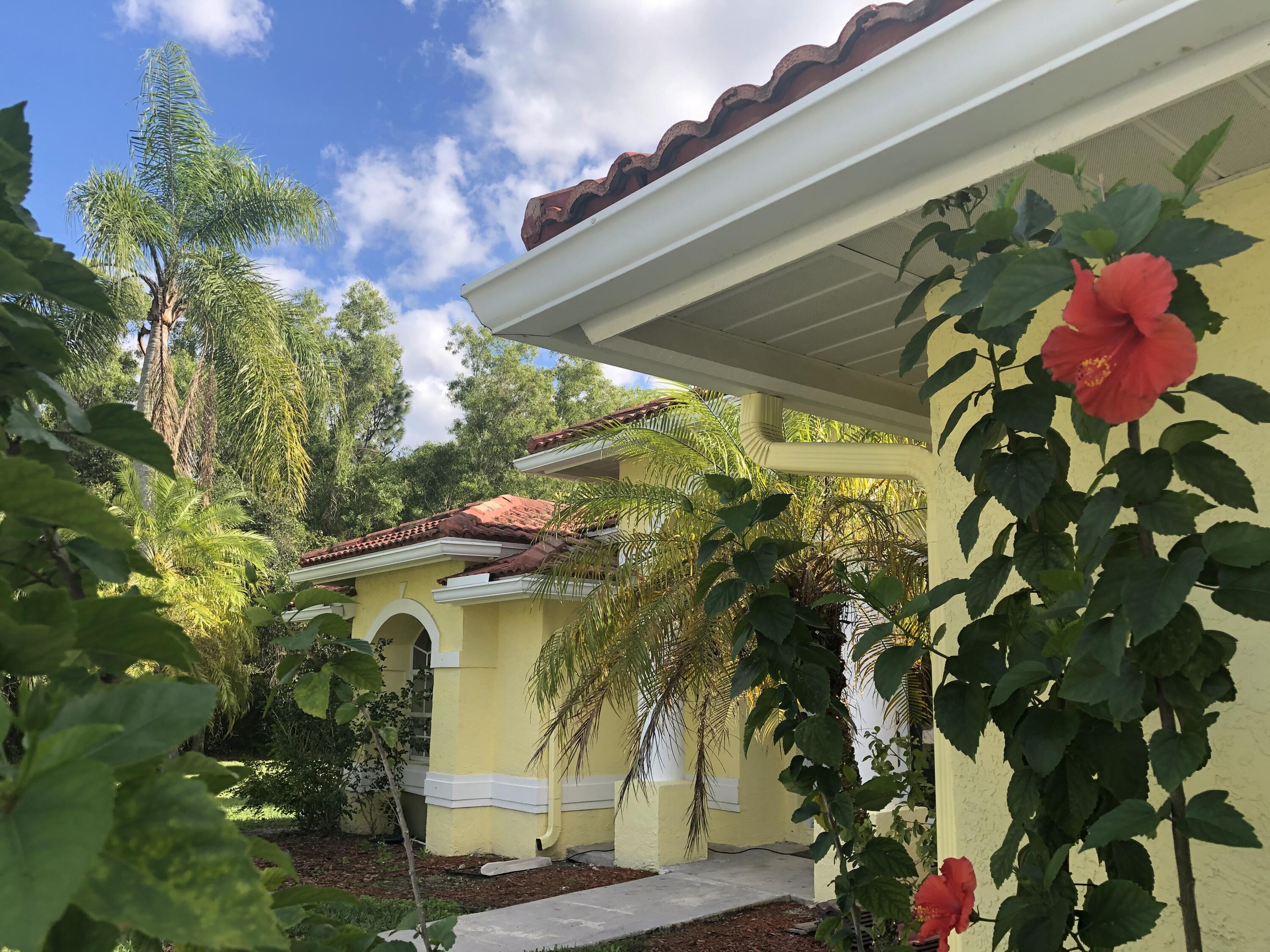 12136 88th Place North West Palm Beach, FL 33412 - Photo 3 of 29 a view of a plant in front of a building