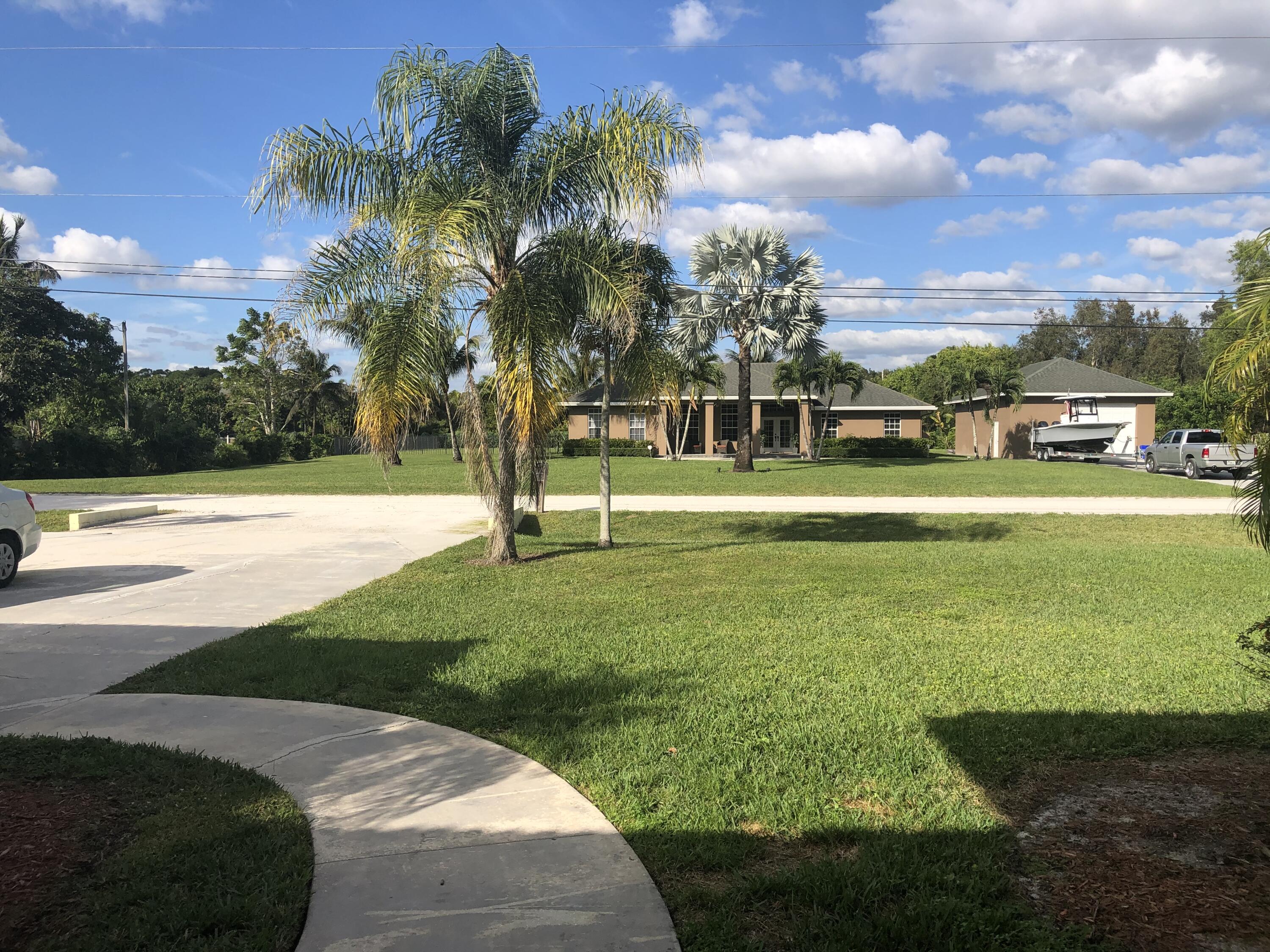 12136 88th Place North West Palm Beach, FL 33412 - Photo 6 of 29 a view of building with garden