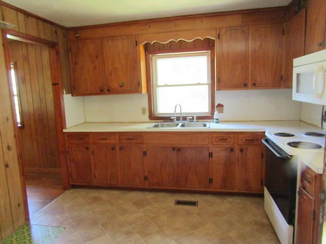 4816 Brush Creek Road Riner, VA 24149 - Photo 5 of 17 a room with a sink cabinets and a window