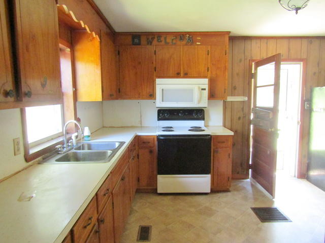 4816 Brush Creek Road Riner, VA 24149 - Photo 7 of 17 a kitchen with stainless steel appliances a stove a sink and a microwave