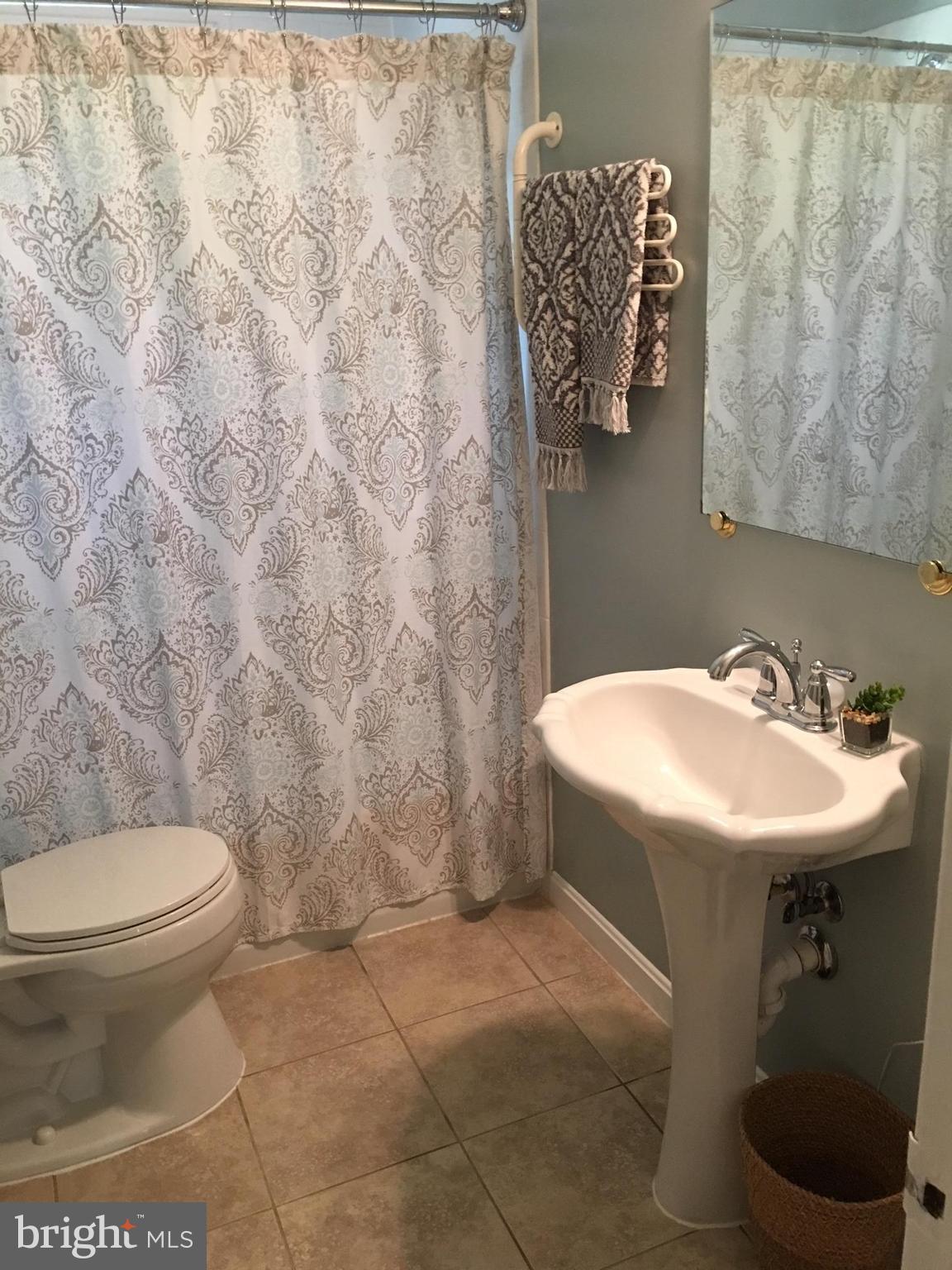 511 Mansfield Road Silver Spring, MD 20910 - Photo 20 of 29 a bathroom with a sink a toilet and a mirror