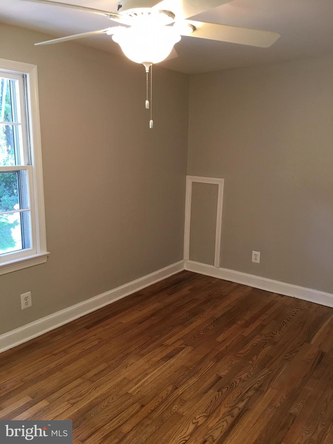 511 Mansfield Road Silver Spring, MD 20910 - Photo 21 of 29 a view of an empty room with wooden floor and a window