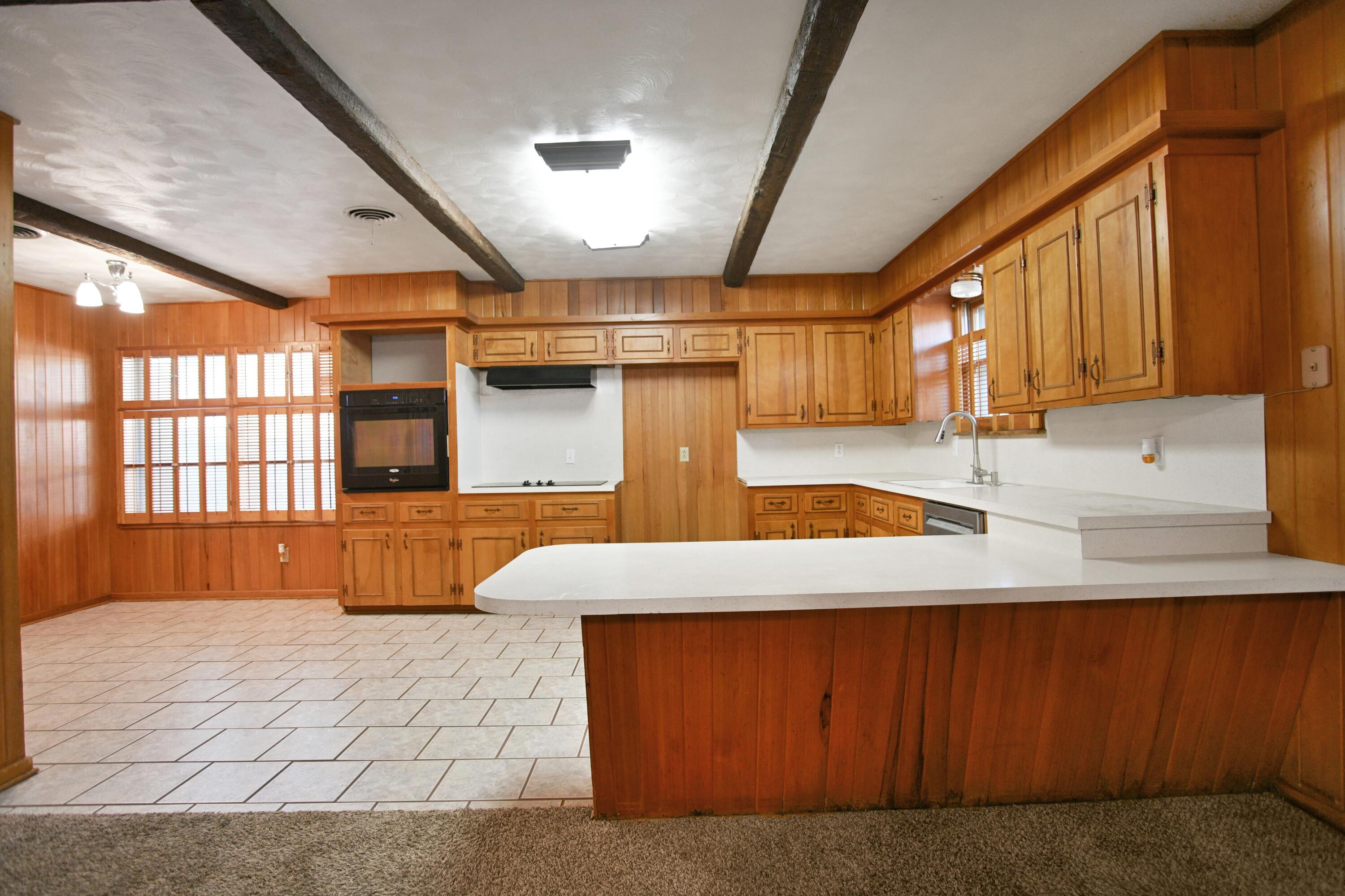 5420 8th Street Lubbock, TX 79416 - Photo 11 of 35 a kitchen with stainless steel appliances kitchen island granite countertop a sink window and cabinets