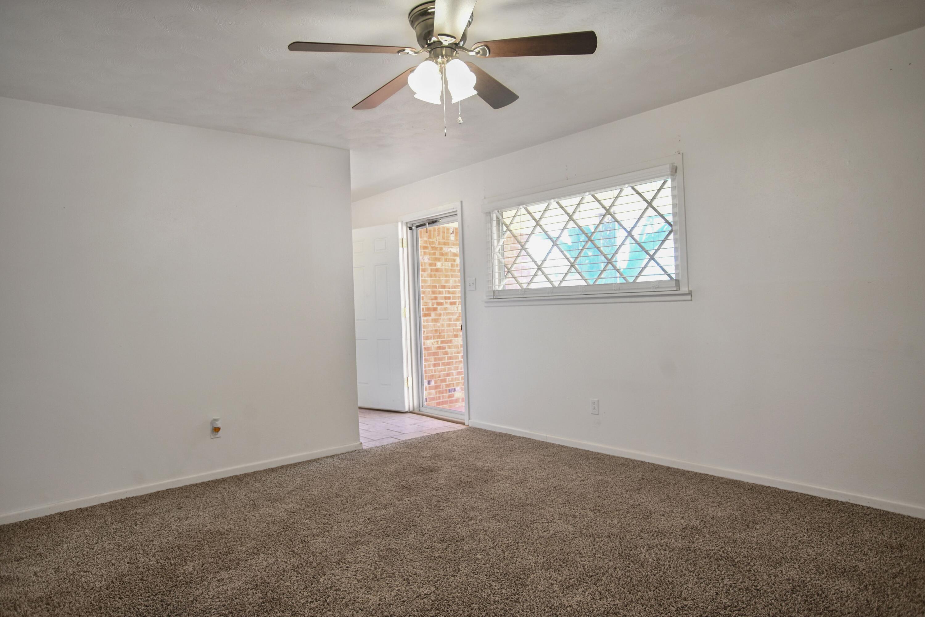 5420 8th Street Lubbock, TX 79416 - Photo 19 of 35 an empty room with windows and fan