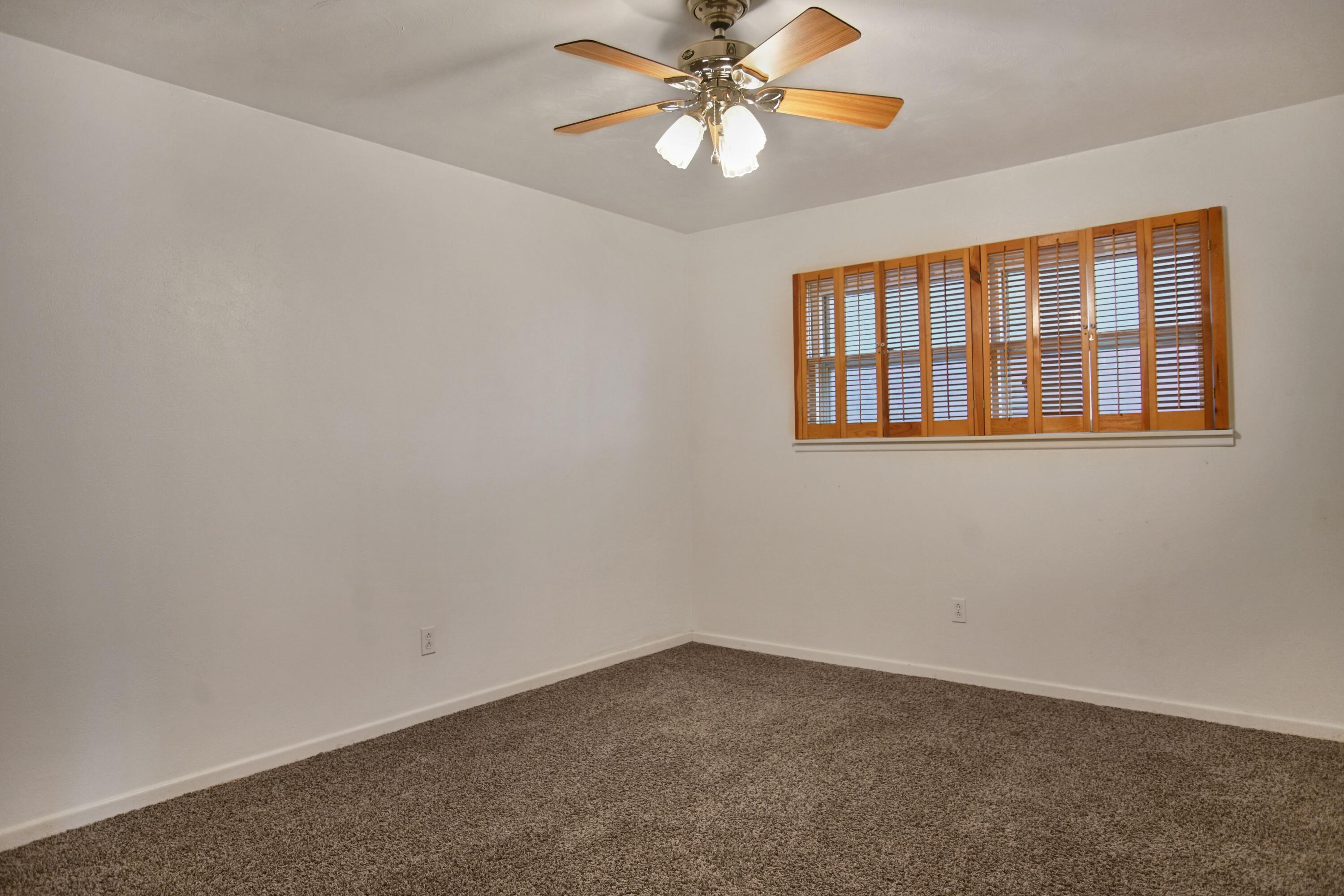 5420 8th Street Lubbock, TX 79416 - Photo 24 of 35 an empty room with windows and fan