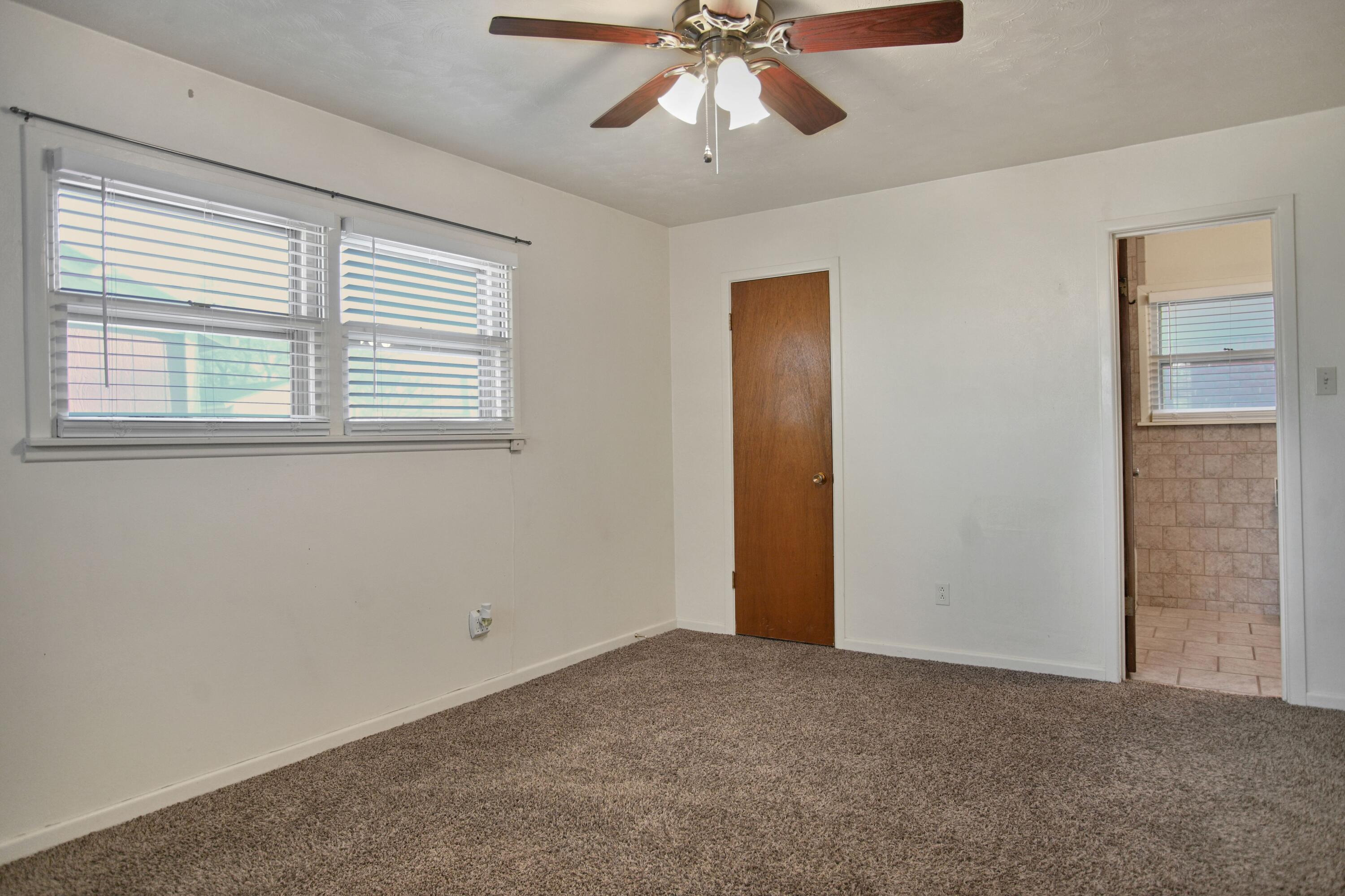 5420 8th Street Lubbock, TX 79416 - Photo 28 of 35 a view of a livingroom with a ceiling fan and window