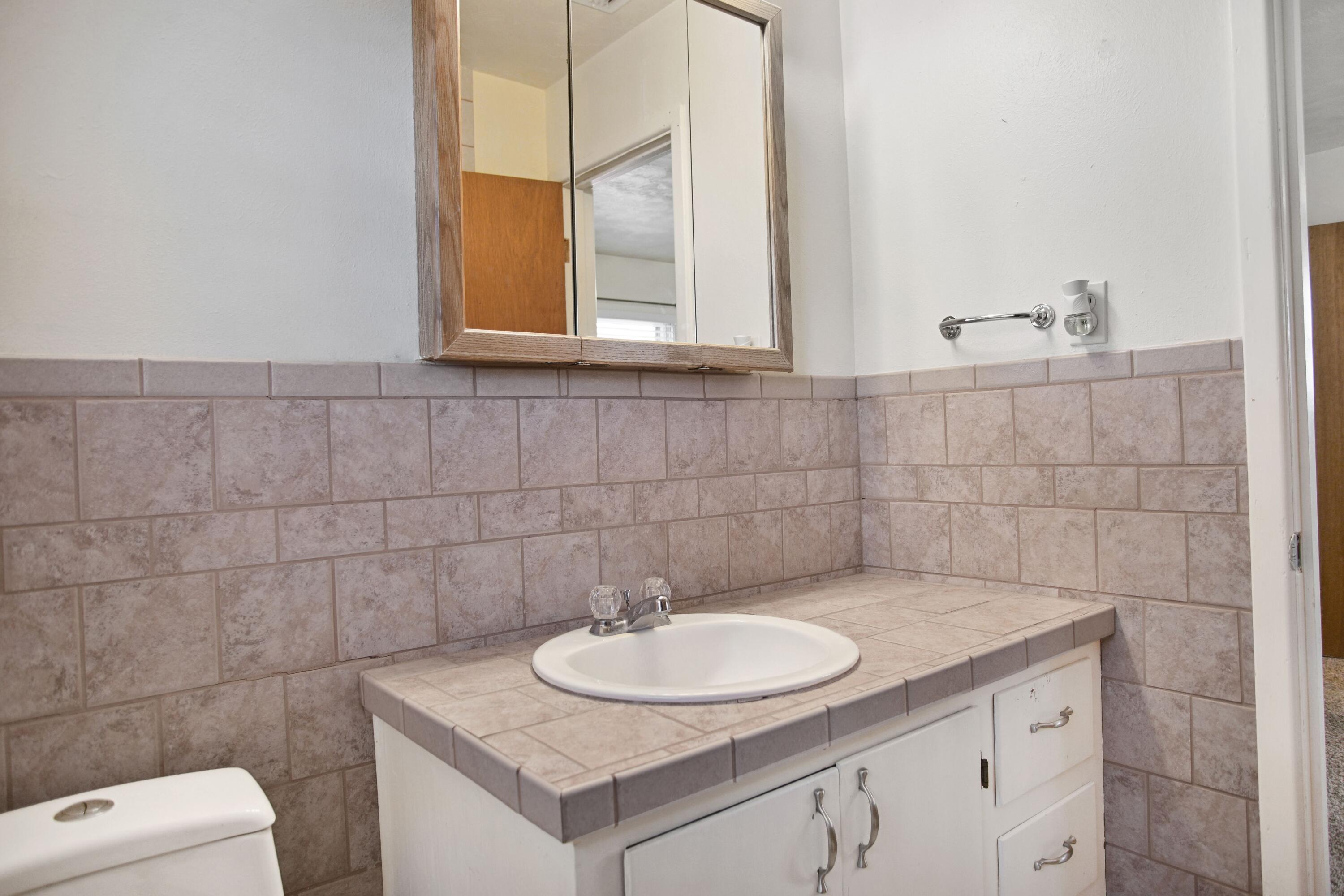 5420 8th Street Lubbock, TX 79416 - Photo 30 of 35 a bathroom with a sink and a toilet