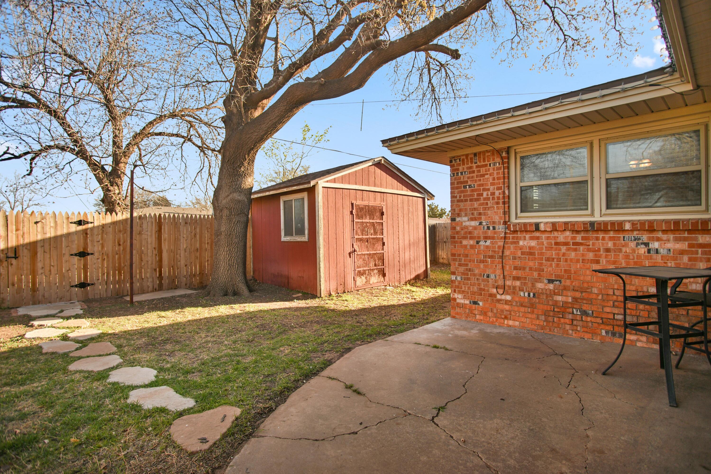 5420 8th Street Lubbock, TX 79416 - Photo 31 of 35 a backyard of a house with table and chairs
