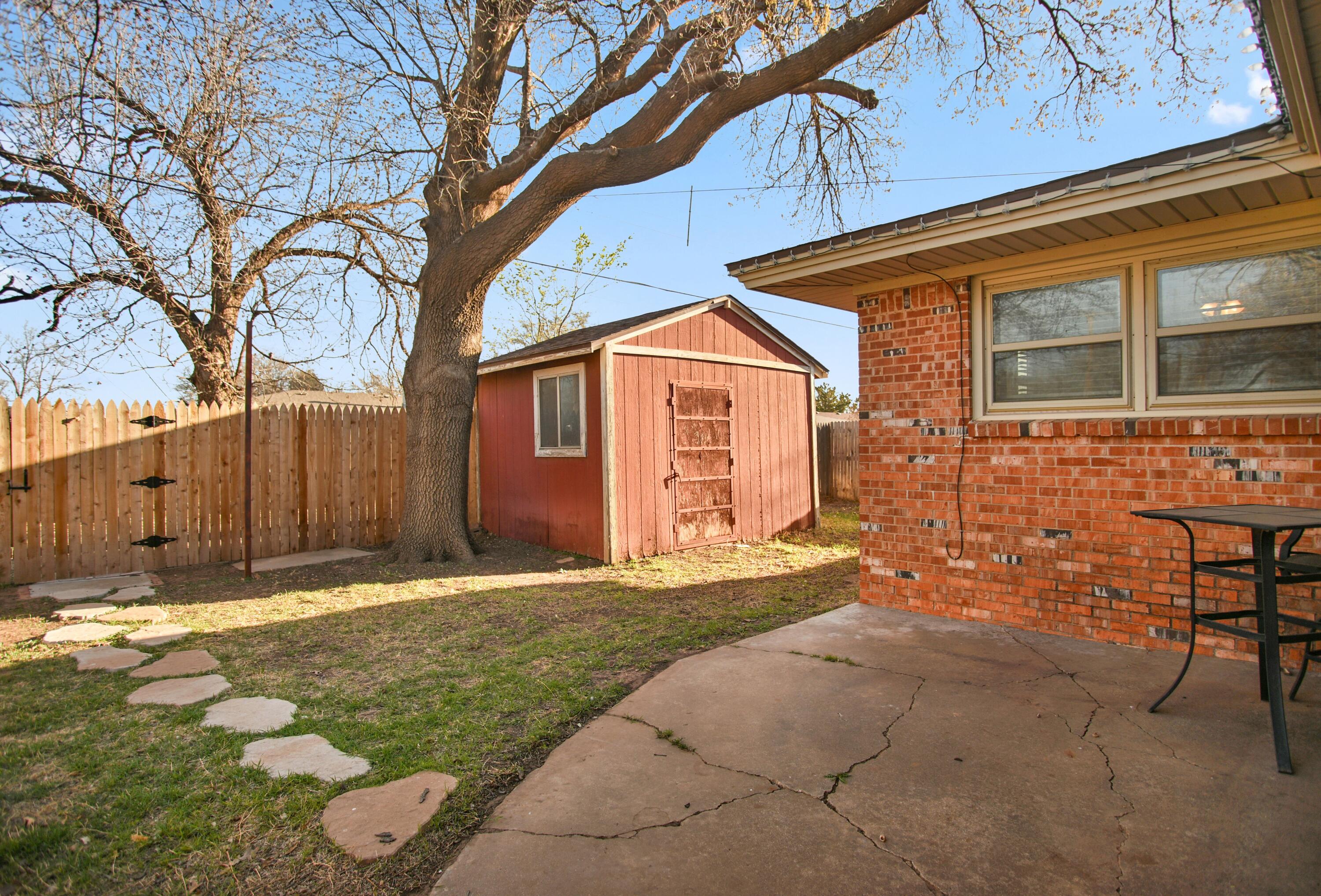 5420 8th Street Lubbock, TX 79416 - Photo 32 of 35 a backyard of a house with table and chairs