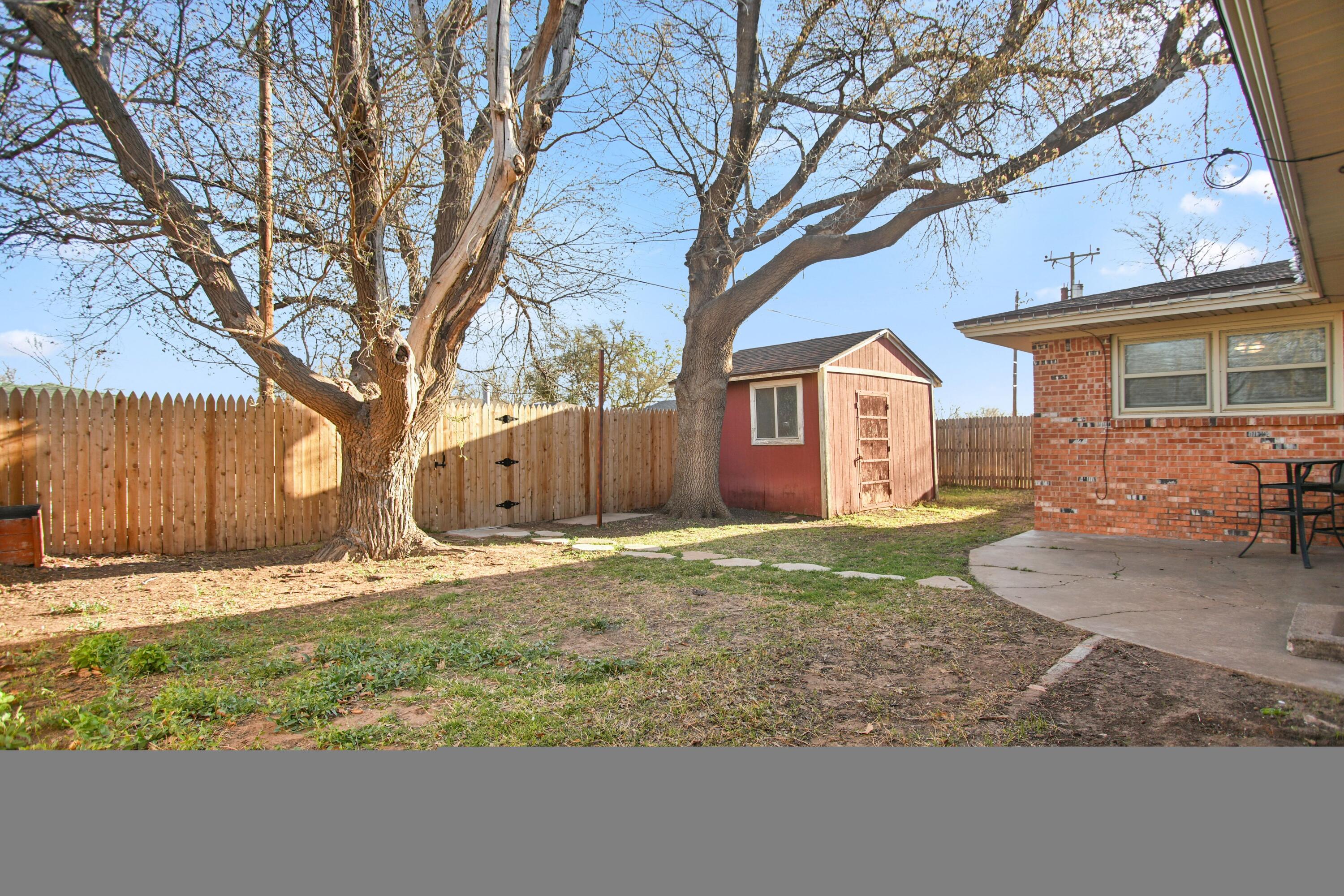 5420 8th Street Lubbock, TX 79416 - Photo 34 of 35 a yard with a tree in front of it