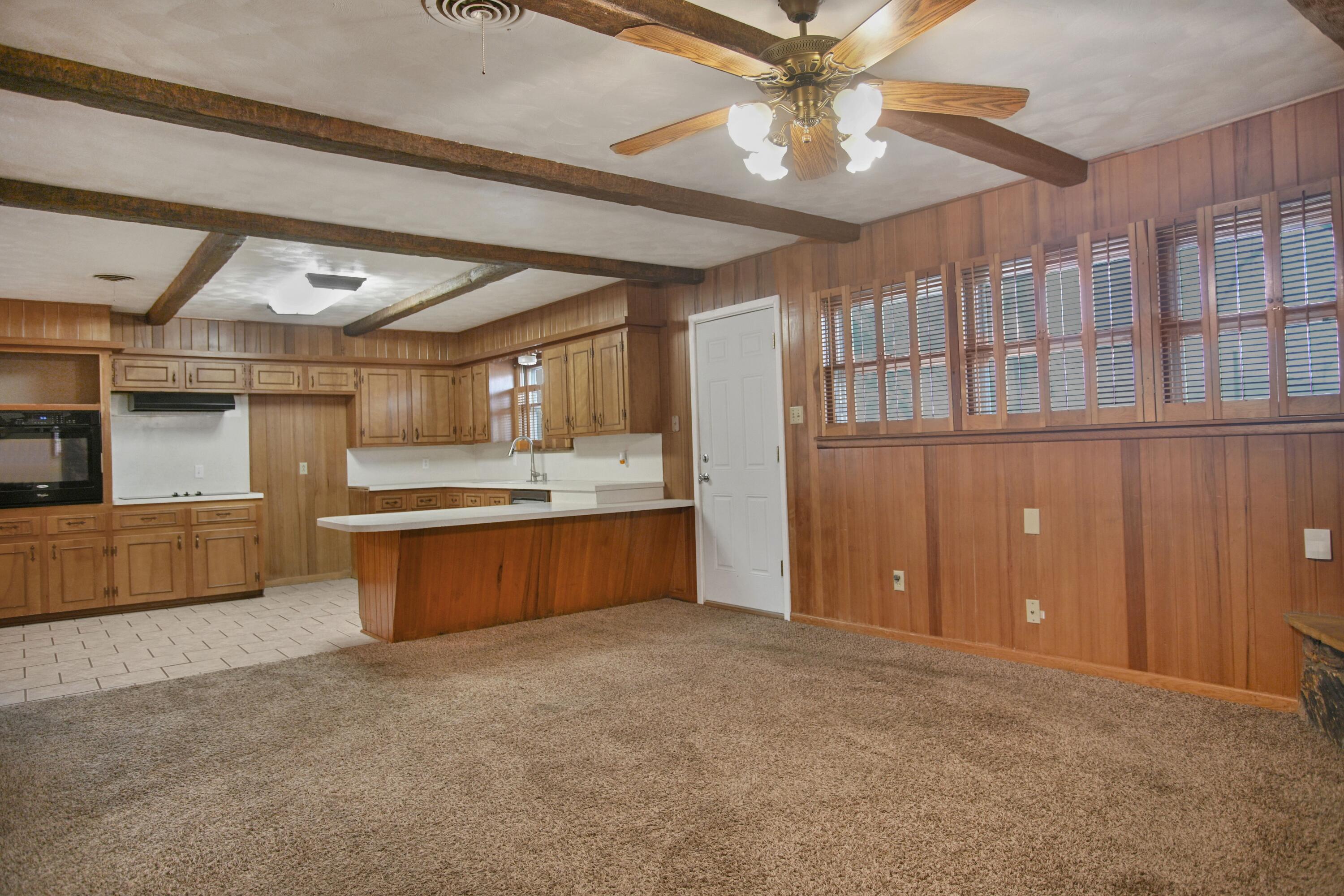 5420 8th Street Lubbock, TX 79416 - Photo 8 of 35 a large kitchen with stainless steel appliances granite countertop a lot of cabinets and couches