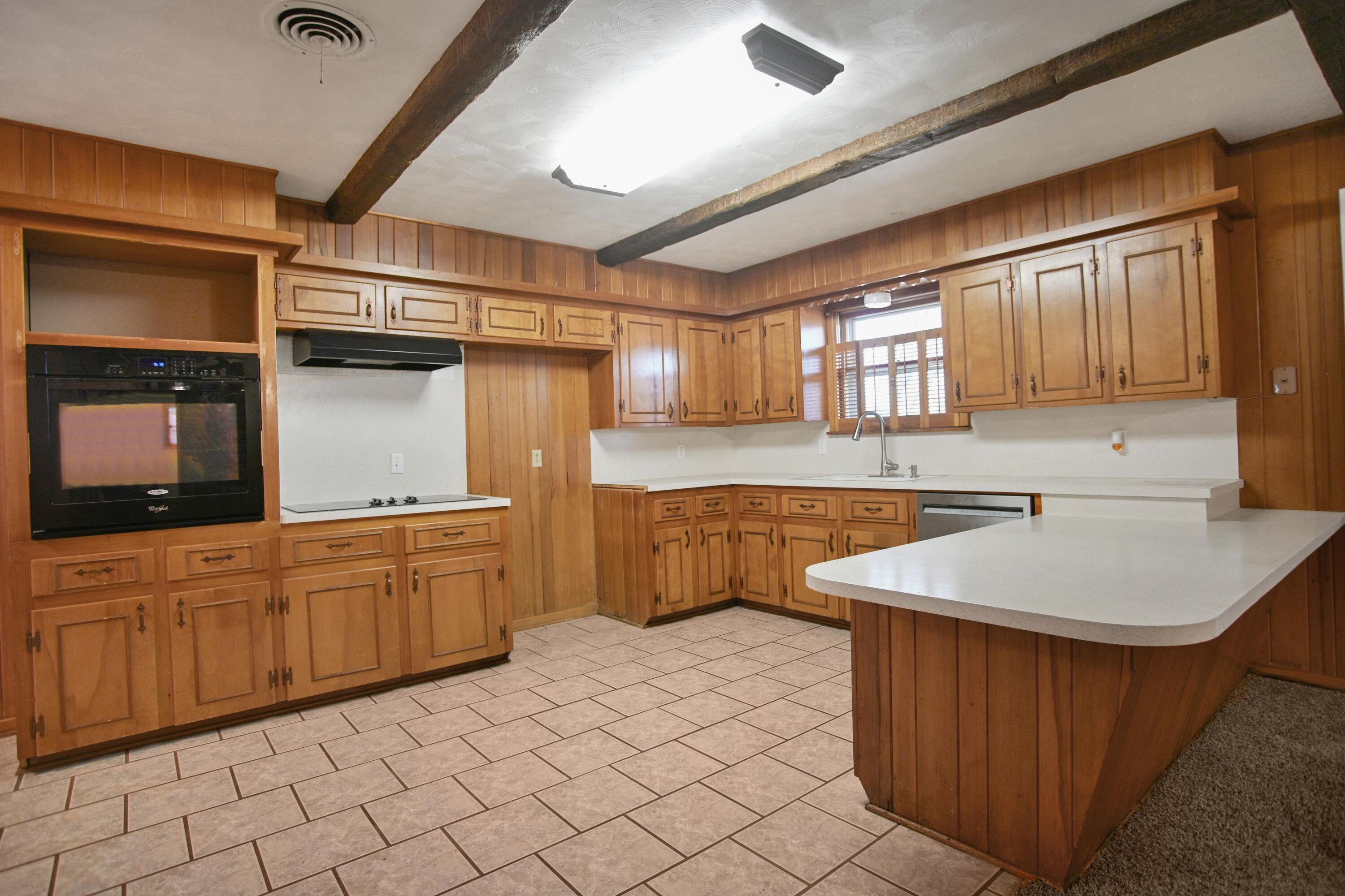 5420 8th Street Lubbock, TX 79416 - Photo 10 of 35 a kitchen with stainless steel appliances granite countertop a sink and a refrigerator