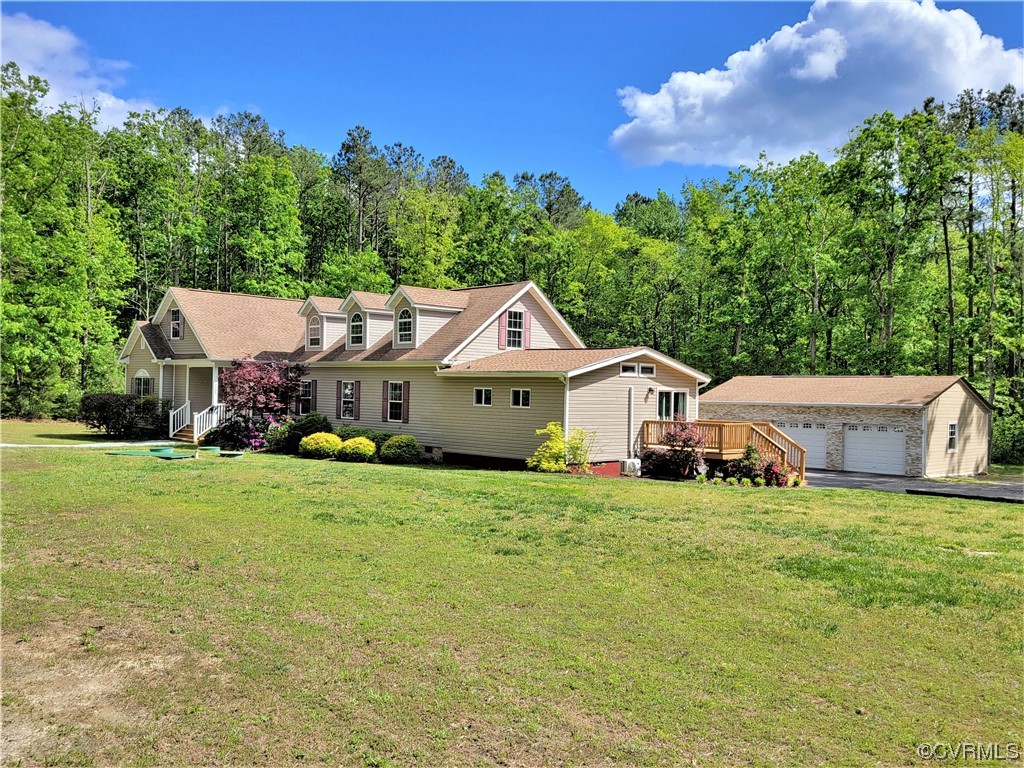 13569 Greenwood Road Glen Allen, VA 23059 - Photo 1 of 49 a house that is sitting in the grass with large trees and plants