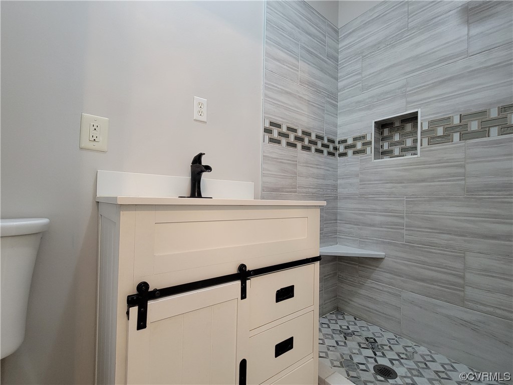 13569 Greenwood Road Glen Allen, VA 23059 - Photo 22 of 49 a bathroom with a sink a mirror and shower