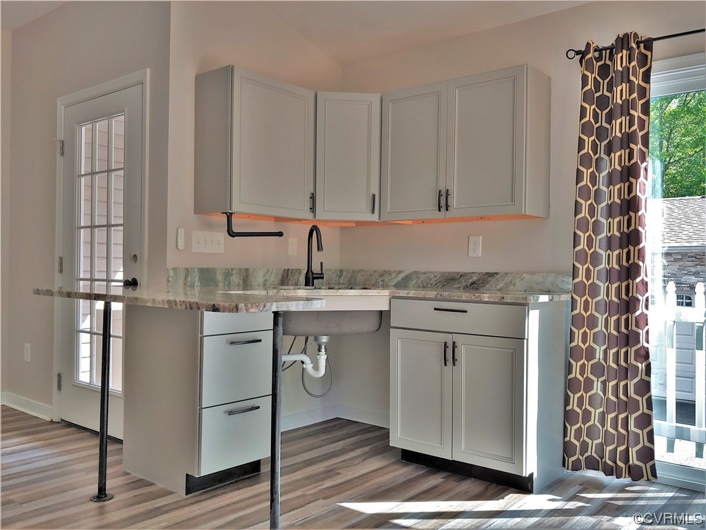 13569 Greenwood Road Glen Allen, VA 23059 - Photo 30 of 49 a kitchen with stainless steel appliances granite countertop a sink stove and cabinets