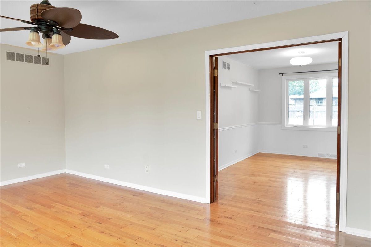 24457 South Tree Ridge Court Channahon, IL 60410 - Photo 6 of 32 a view of an empty room with wooden floor and a window