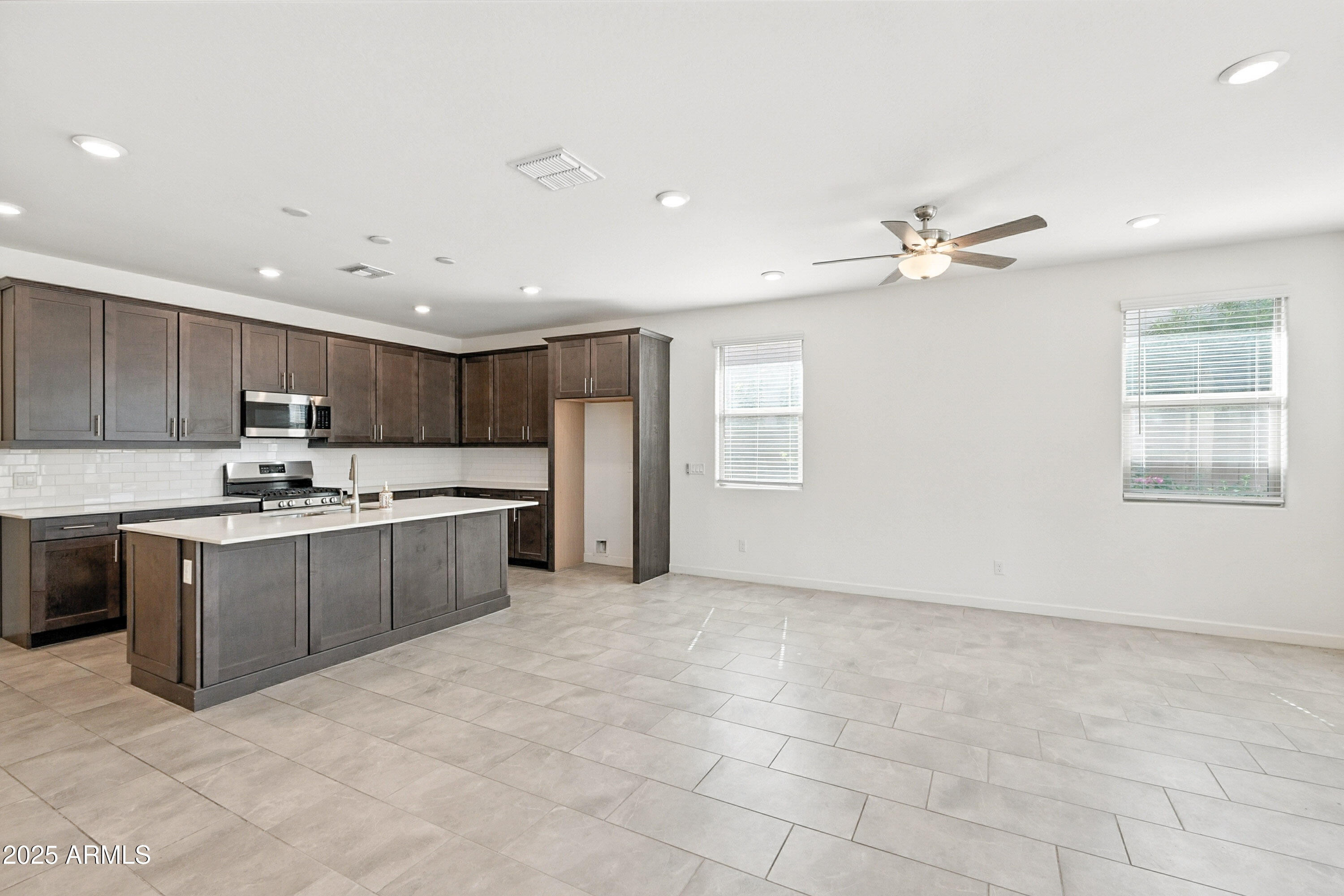 2816 West Pollack Street Phoenix, AZ 85041 - Photo 12 of 63 a large kitchen with kitchen island a sink stainless steel appliances and cabinets