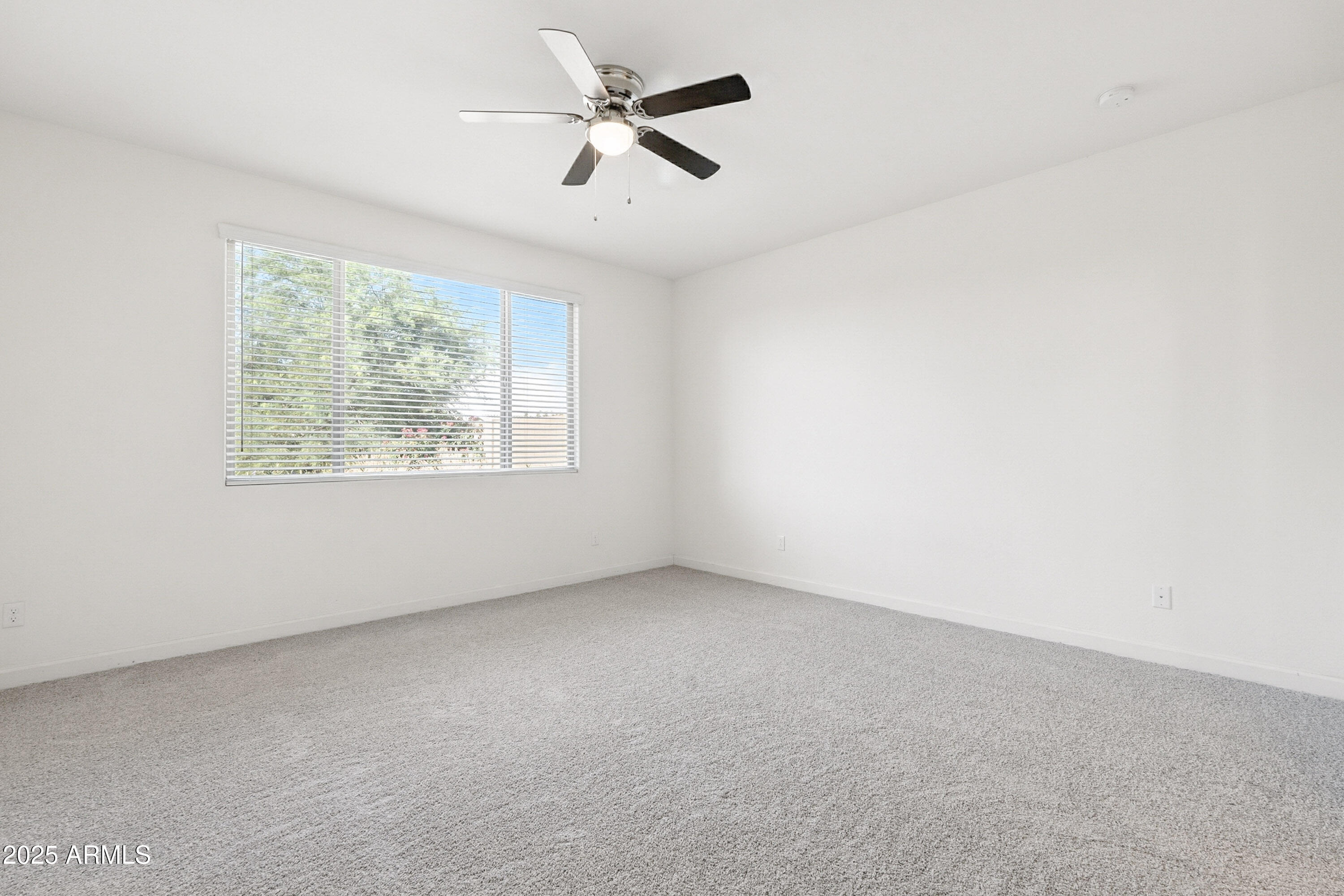 2816 West Pollack Street Phoenix, AZ 85041 - Photo 16 of 63 an empty room with windows and fan