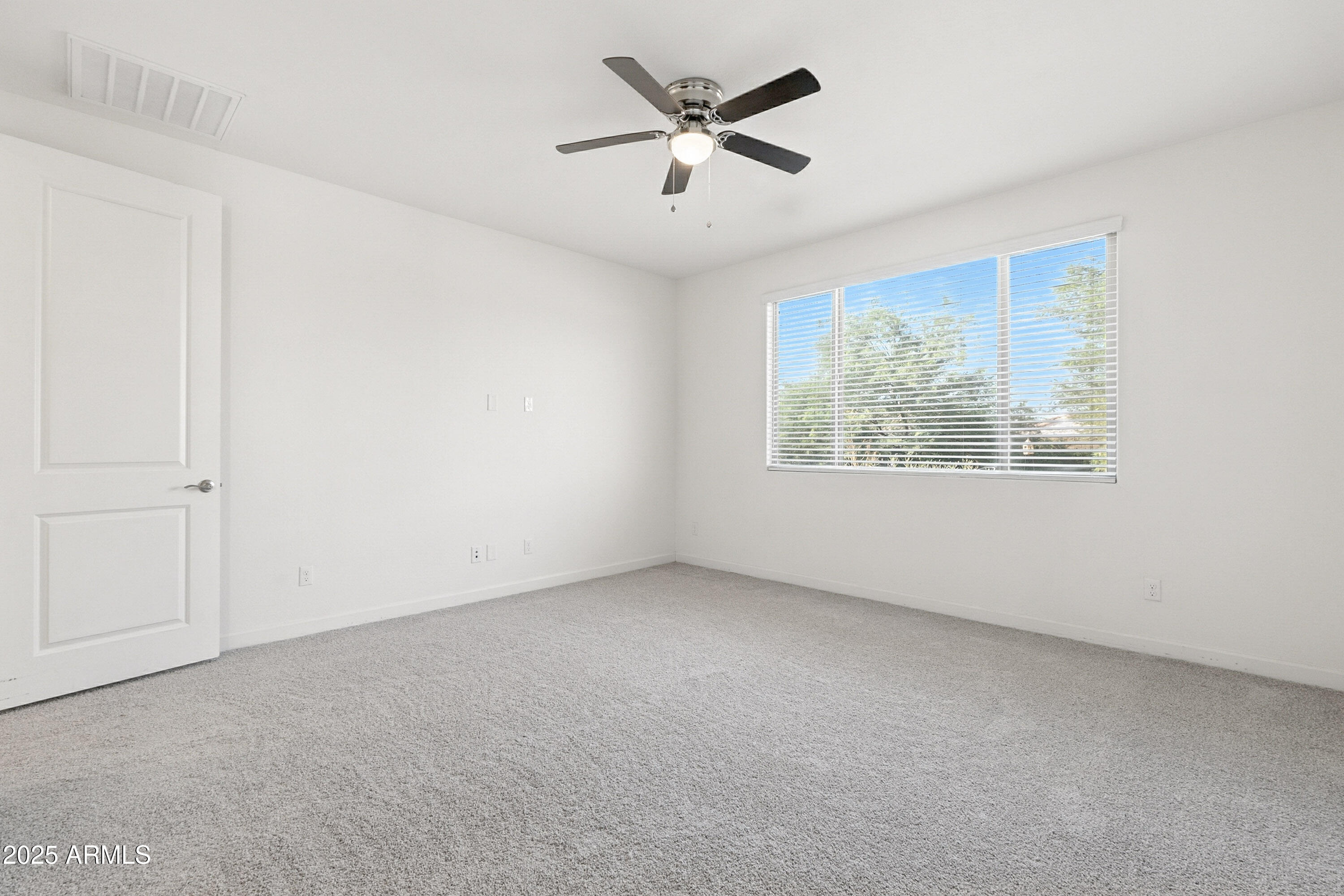 2816 West Pollack Street Phoenix, AZ 85041 - Photo 22 of 63 an empty room with a window and a ceiling fan