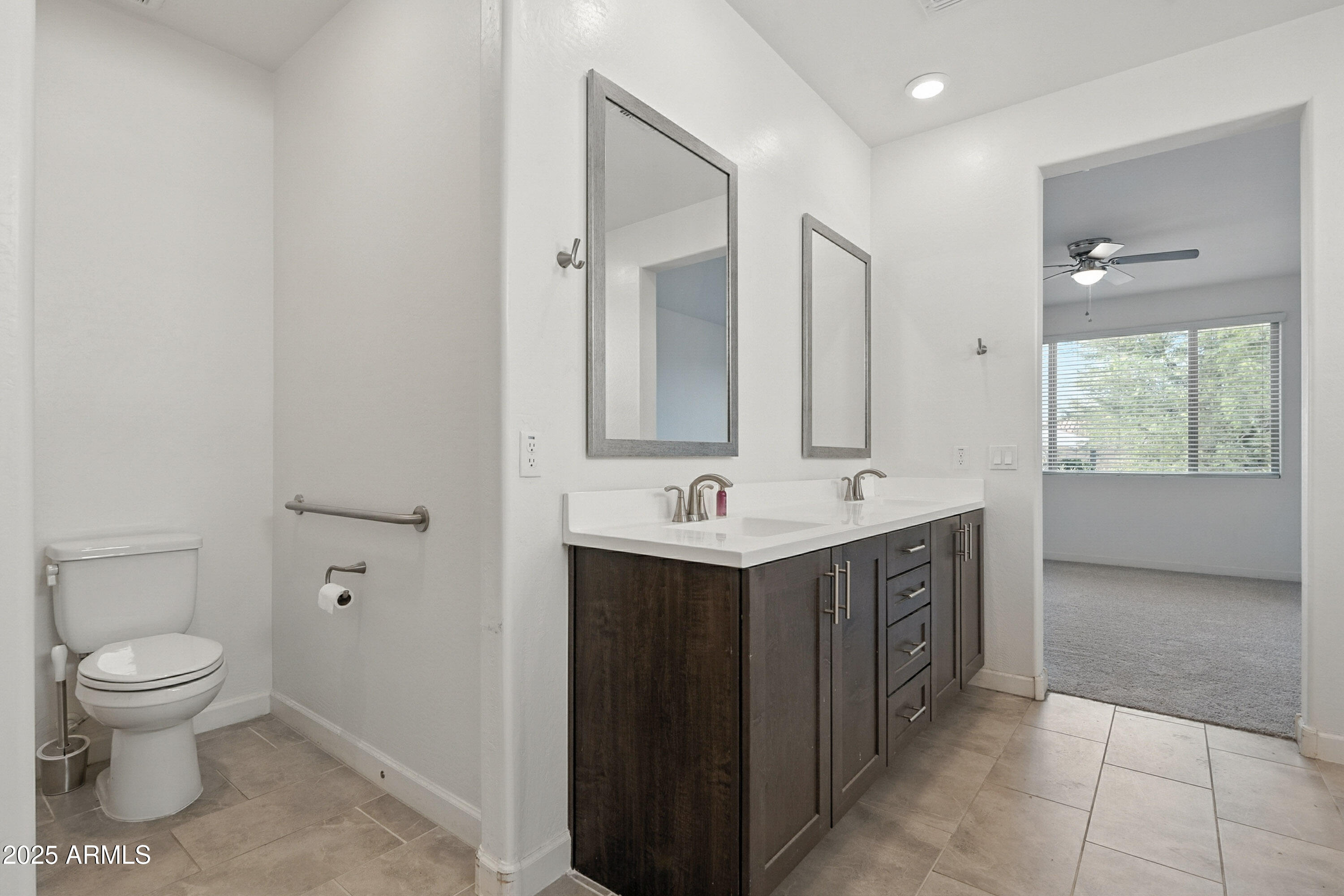 2816 West Pollack Street Phoenix, AZ 85041 - Photo 26 of 63 a view of bathroom with a toilet sink and mirror