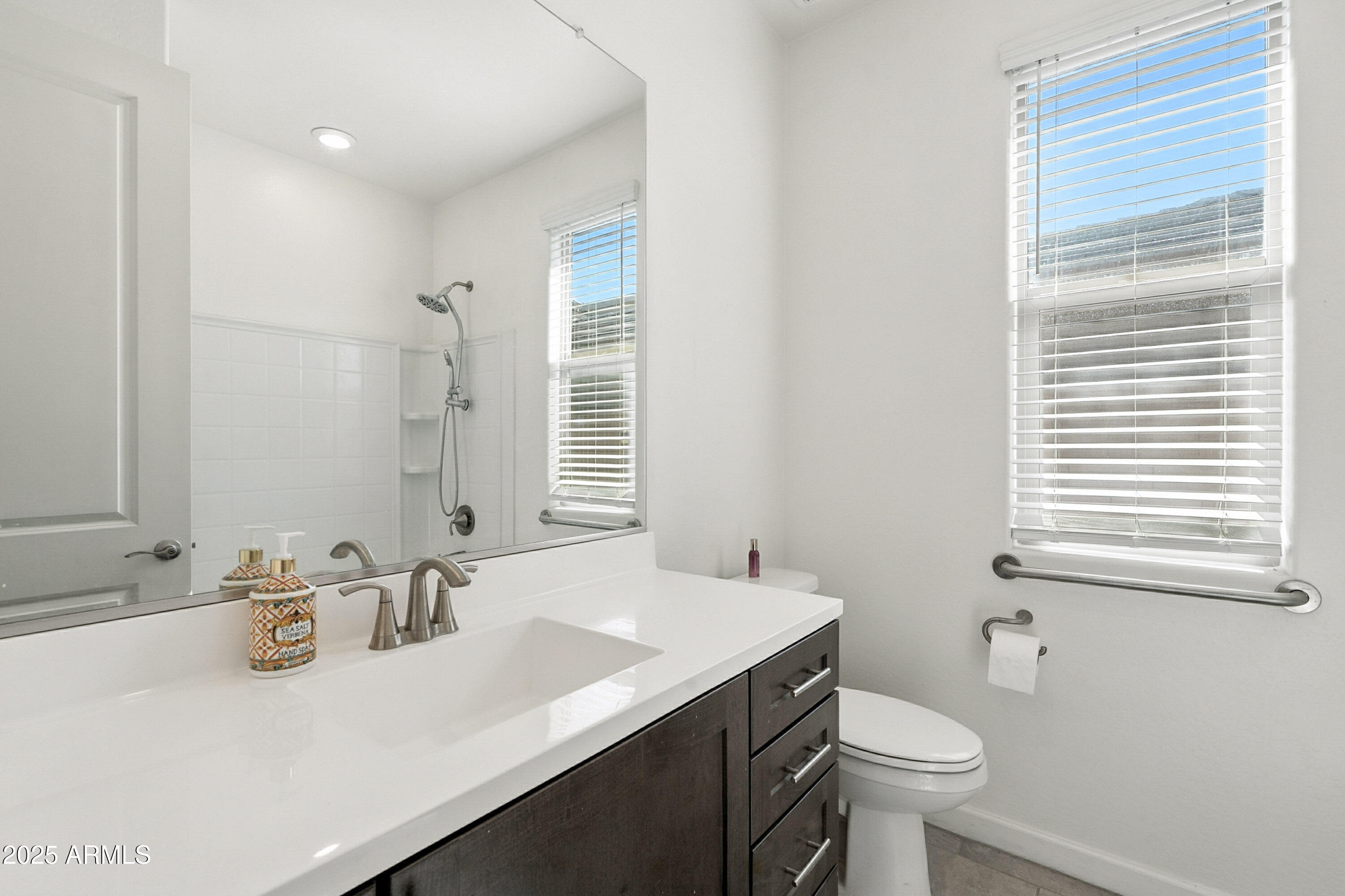 2816 West Pollack Street Phoenix, AZ 85041 - Photo 31 of 63 a bathroom with a sink toilet a mirror and shower
