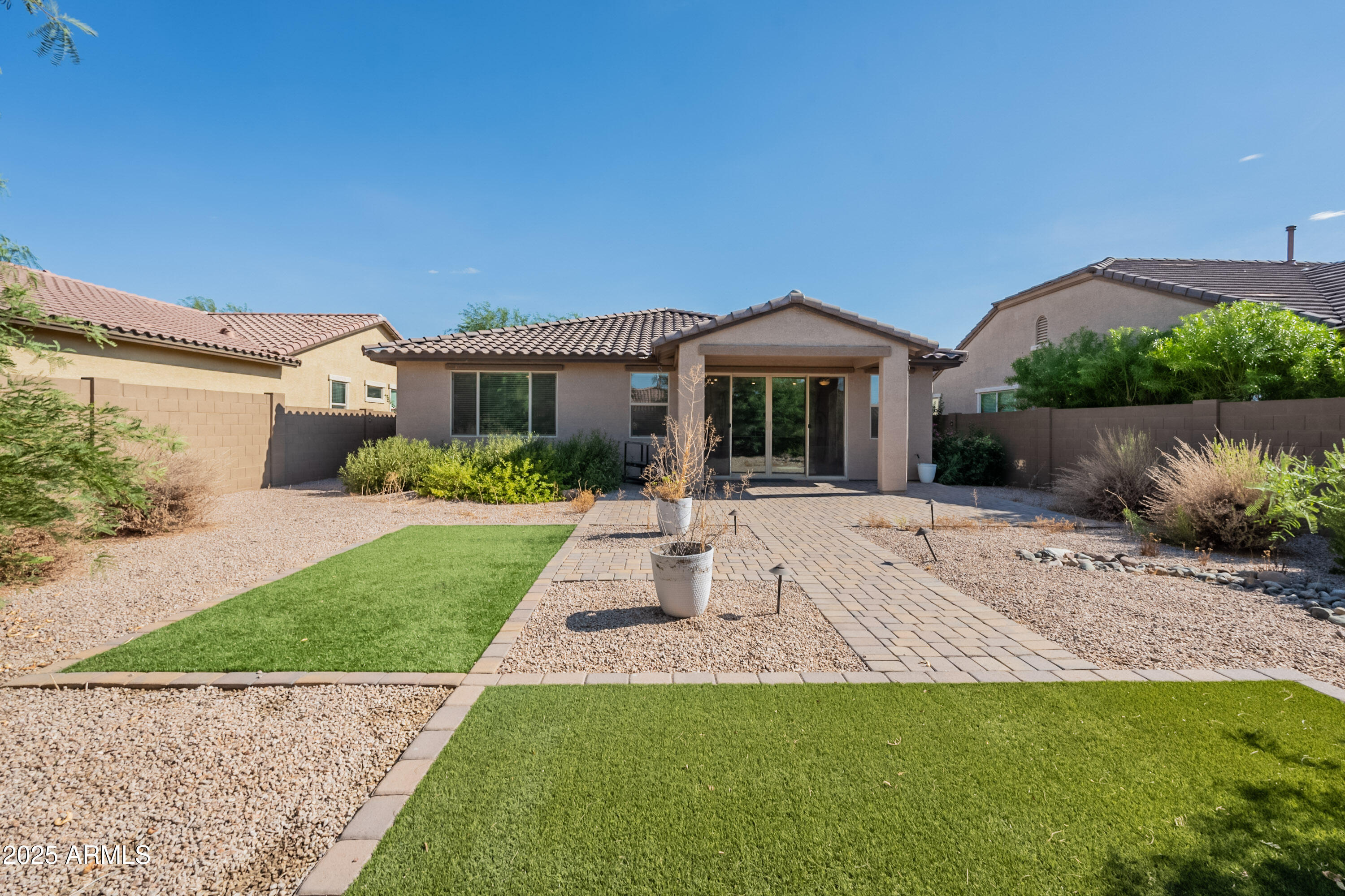 2816 West Pollack Street Phoenix, AZ 85041 - Photo 46 of 63 a front view of a house with a garden and yard