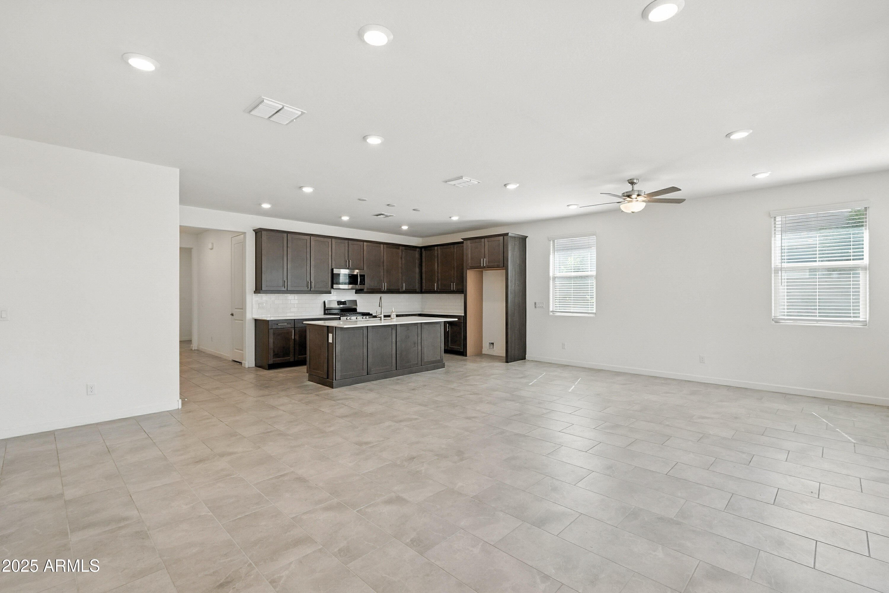 2816 West Pollack Street Phoenix, AZ 85041 - Photo 53 of 63 a large white kitchen with a sink a window and stainless steel appliances