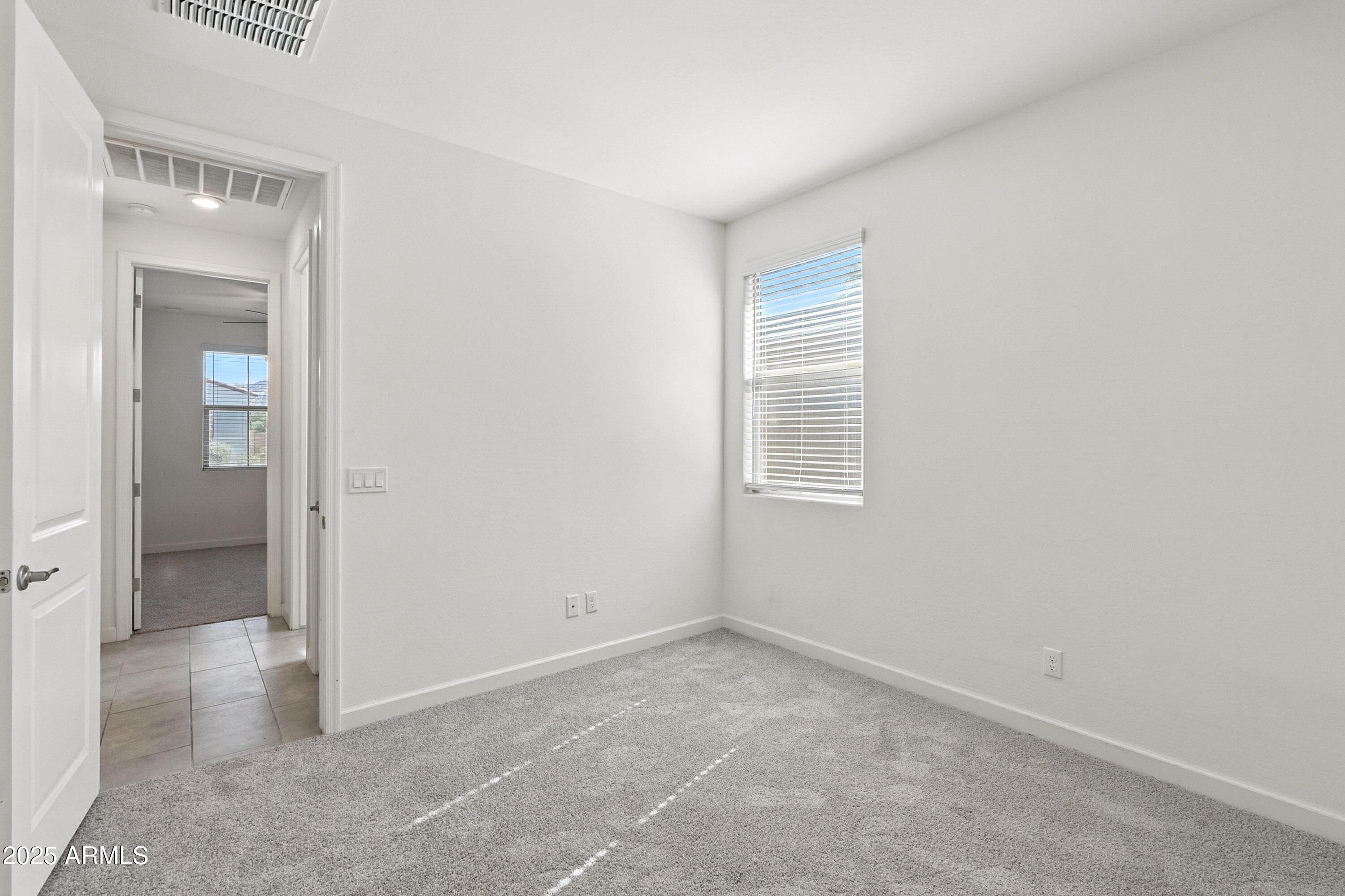 2816 West Pollack Street Phoenix, AZ 85041 - Photo 61 of 63 an empty room with windows and entrance