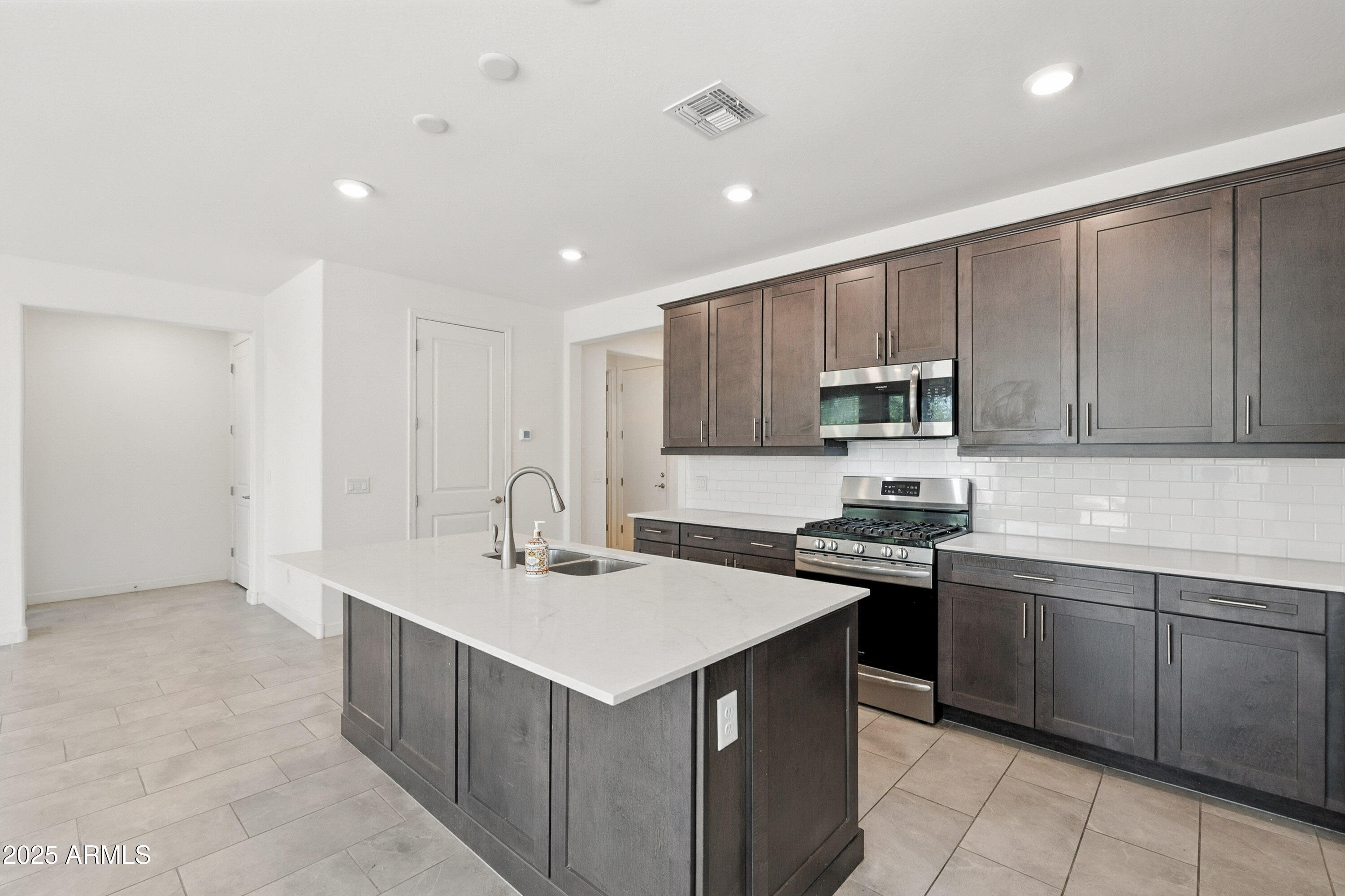 2816 West Pollack Street Phoenix, AZ 85041 - Photo 7 of 63 a kitchen that has a sink and a stove in it