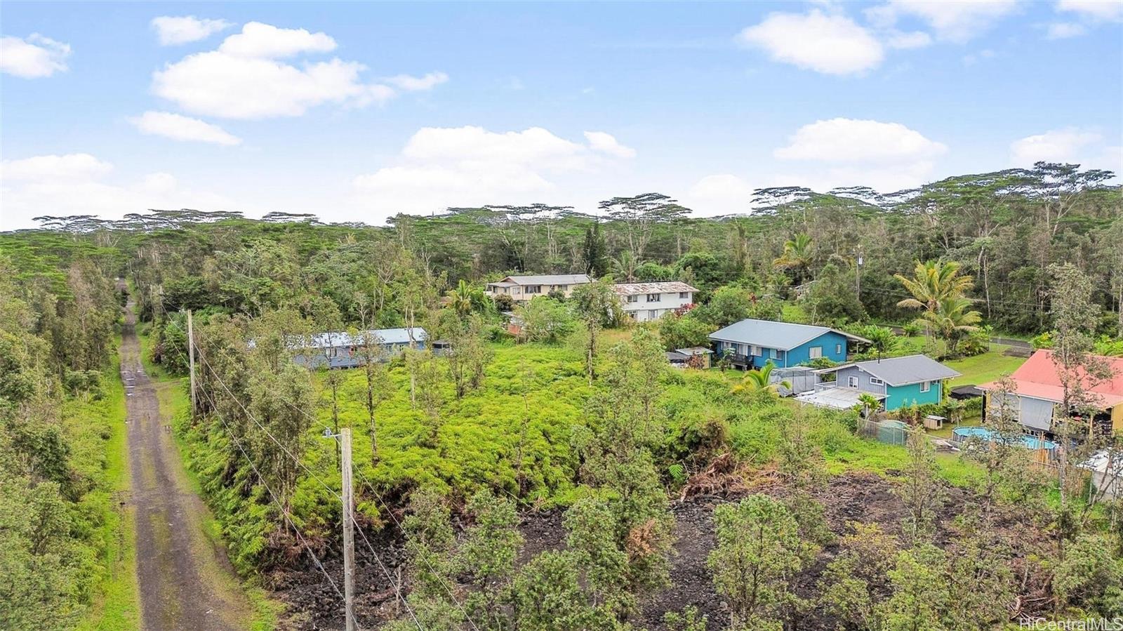 14-3440 Oahu Road, Unit LOT 917 Pahoa, HI 96778 - Photo 17 of 25 a view of a garden with mountains in the background