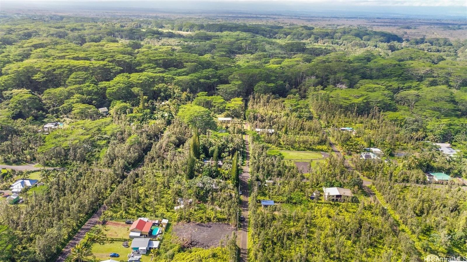 14-3440 Oahu Road, Unit LOT 917 Pahoa, HI 96778 - Photo 23 of 25 an aerial view of residential houses with outdoor space and trees