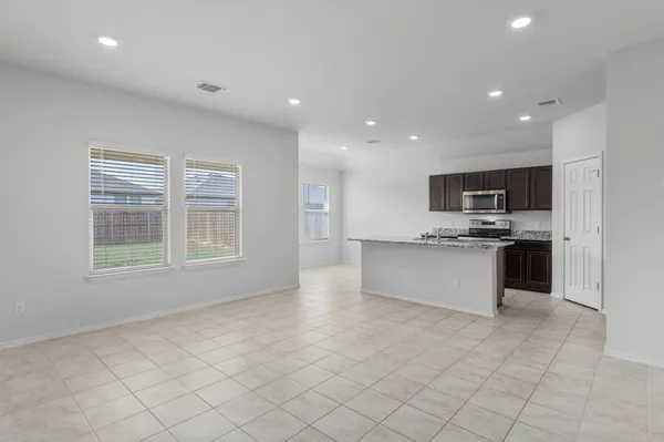 a large kitchen with stainless steel appliances granite countertop a large counter top and a stove top oven