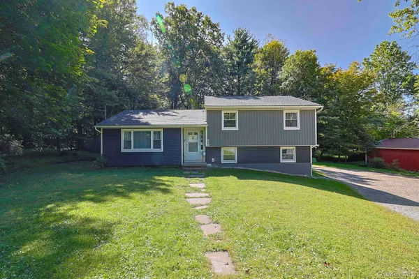 a view of a house with swimming pool next to a yard