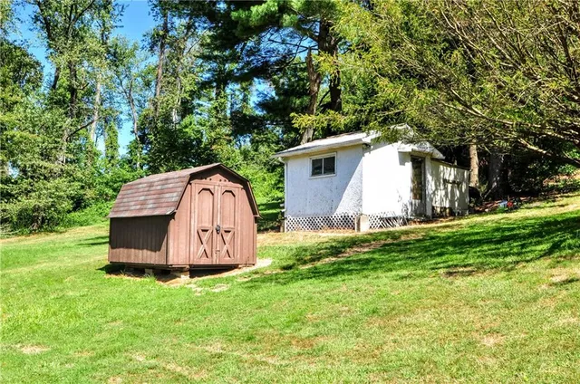 a view of a backyard with small cabin