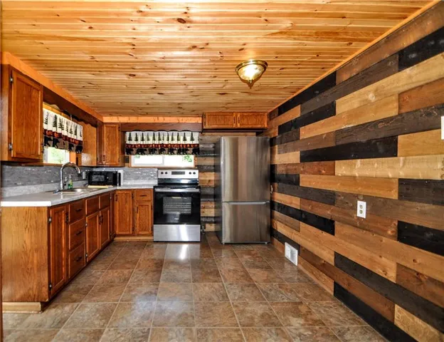 a kitchen with stainless steel appliances and cabinets