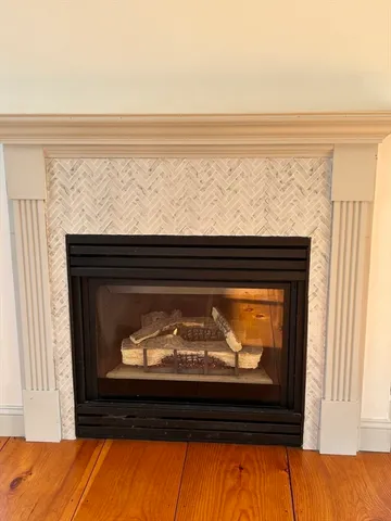 a view of fireplace with wooden floor