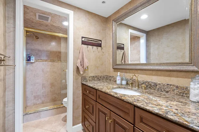 a bathroom with a granite countertop sink mirror and double