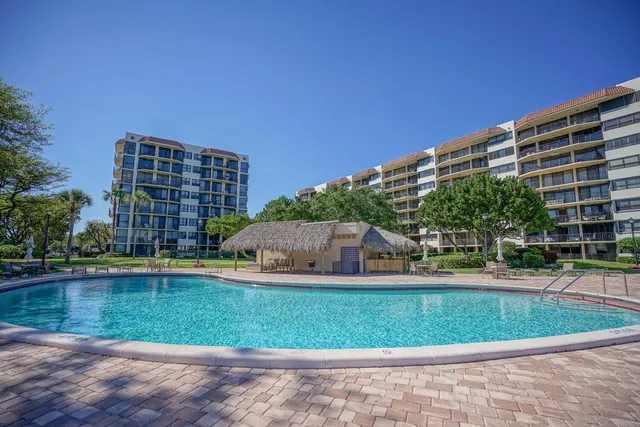 a view of swimming pool with outdoor seating and plants