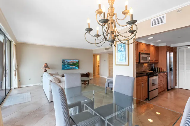 a view of a dining room with furniture wooden floor and a chandelier