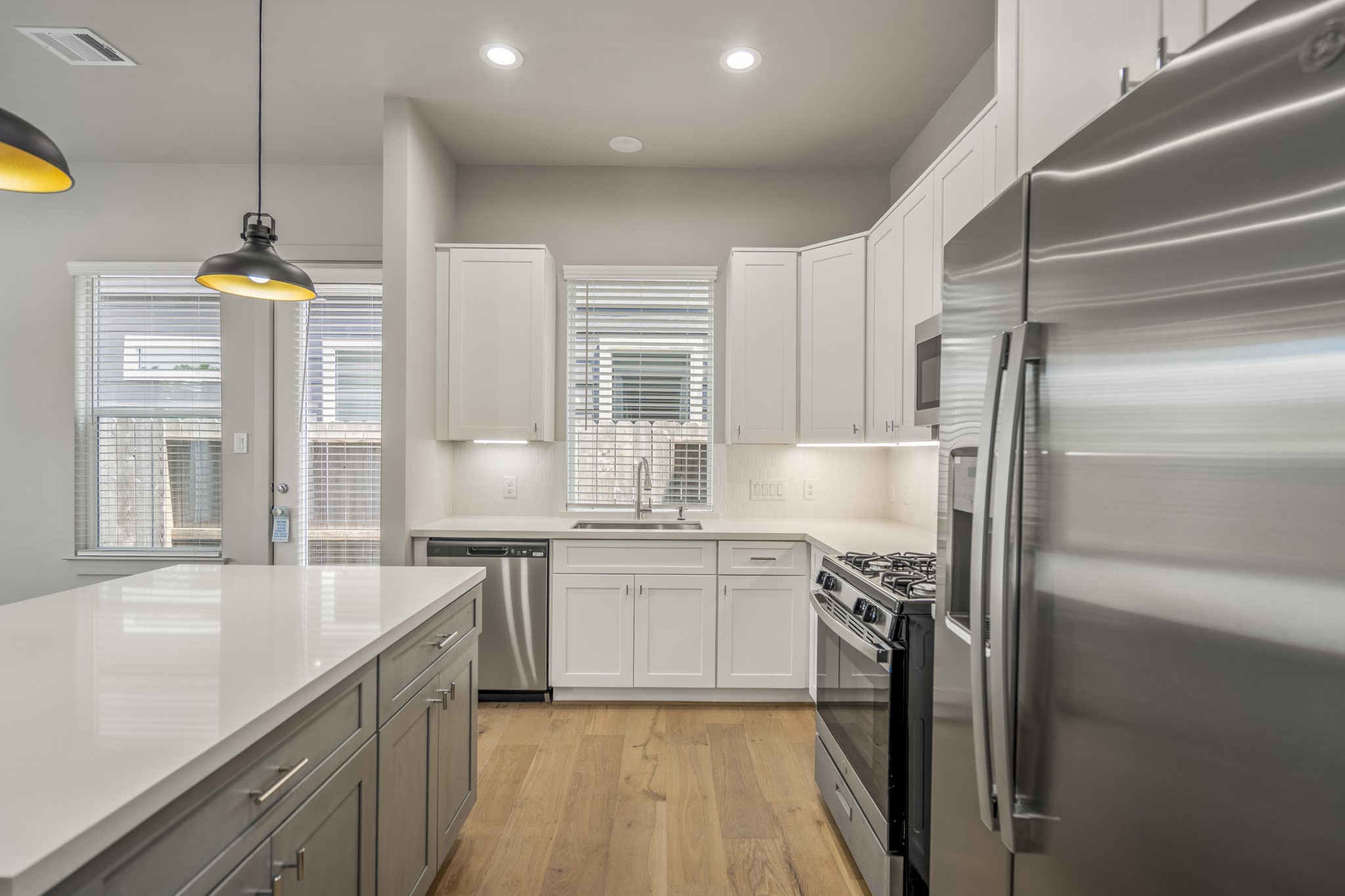 5229 Hillman Street, Unit A Houston, TX 77023 - Photo 11 of 50 a kitchen with stainless steel appliances granite countertop a sink a stove and a refrigerator