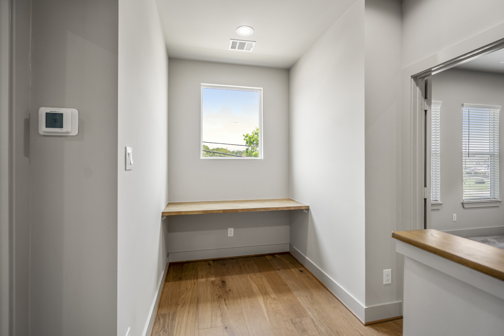 5229 Hillman Street, Unit A Houston, TX 77023 - Photo 31 of 50 a room with window and a wooden floor