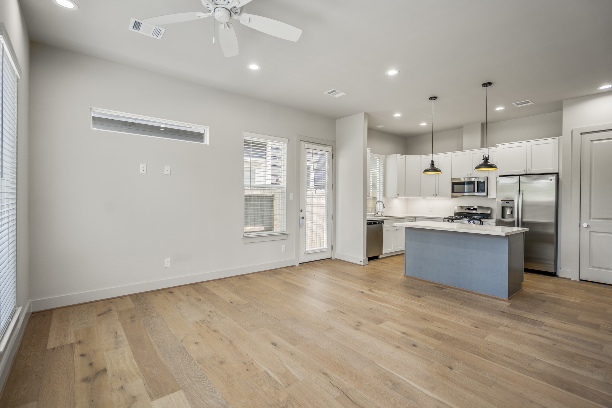 5229 Hillman Street, Unit A Houston, TX 77023 - Photo 3 of 50 a large kitchen with stainless steel appliances kitchen island a large counter top and a wooden floors